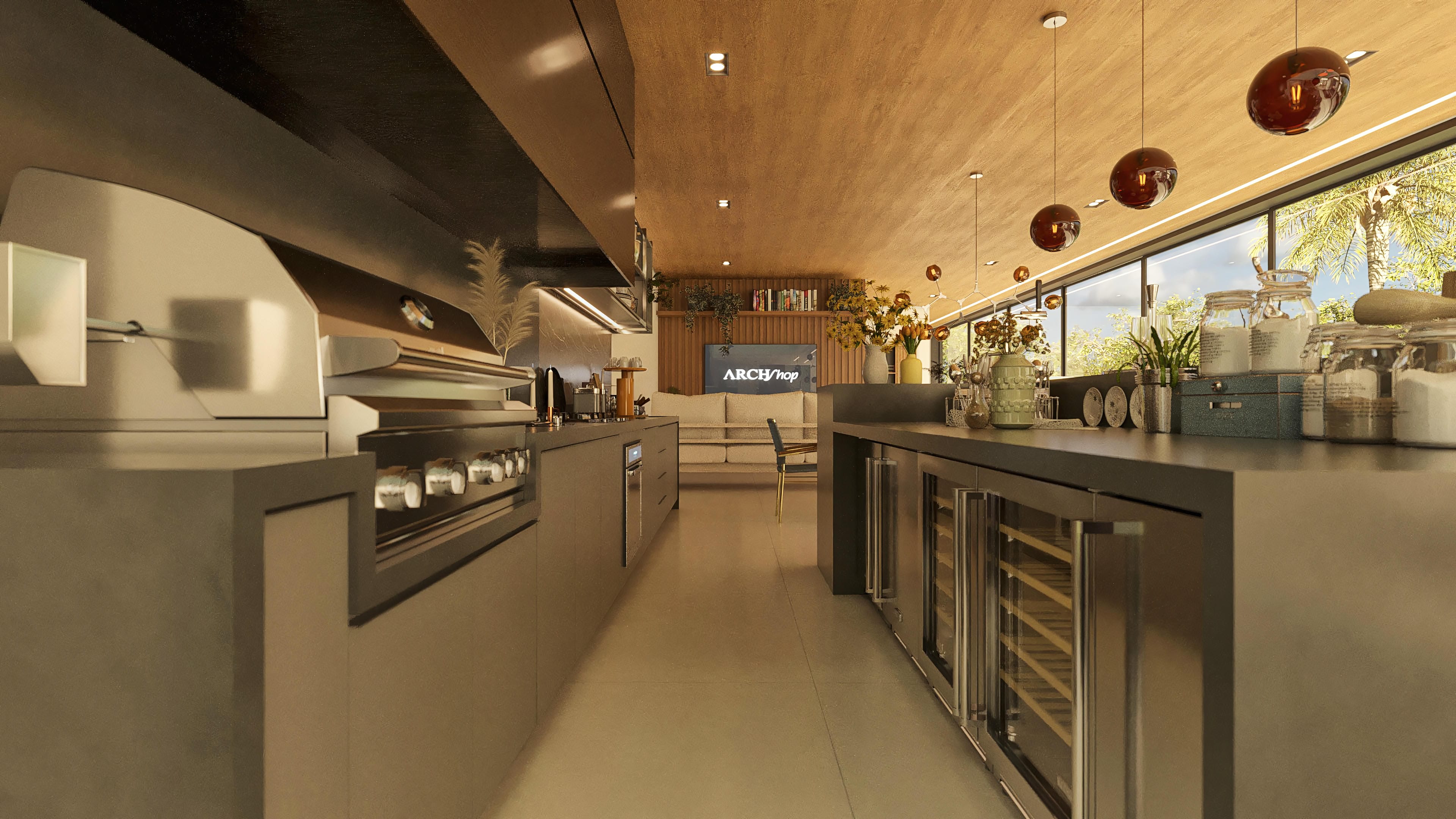 Interior de cocina moderna con isla central, bodega climatizada, encimeras de cuarzo e iluminación empotrada, integrándose a una sala de estar con vistas al exuberante exterior.
