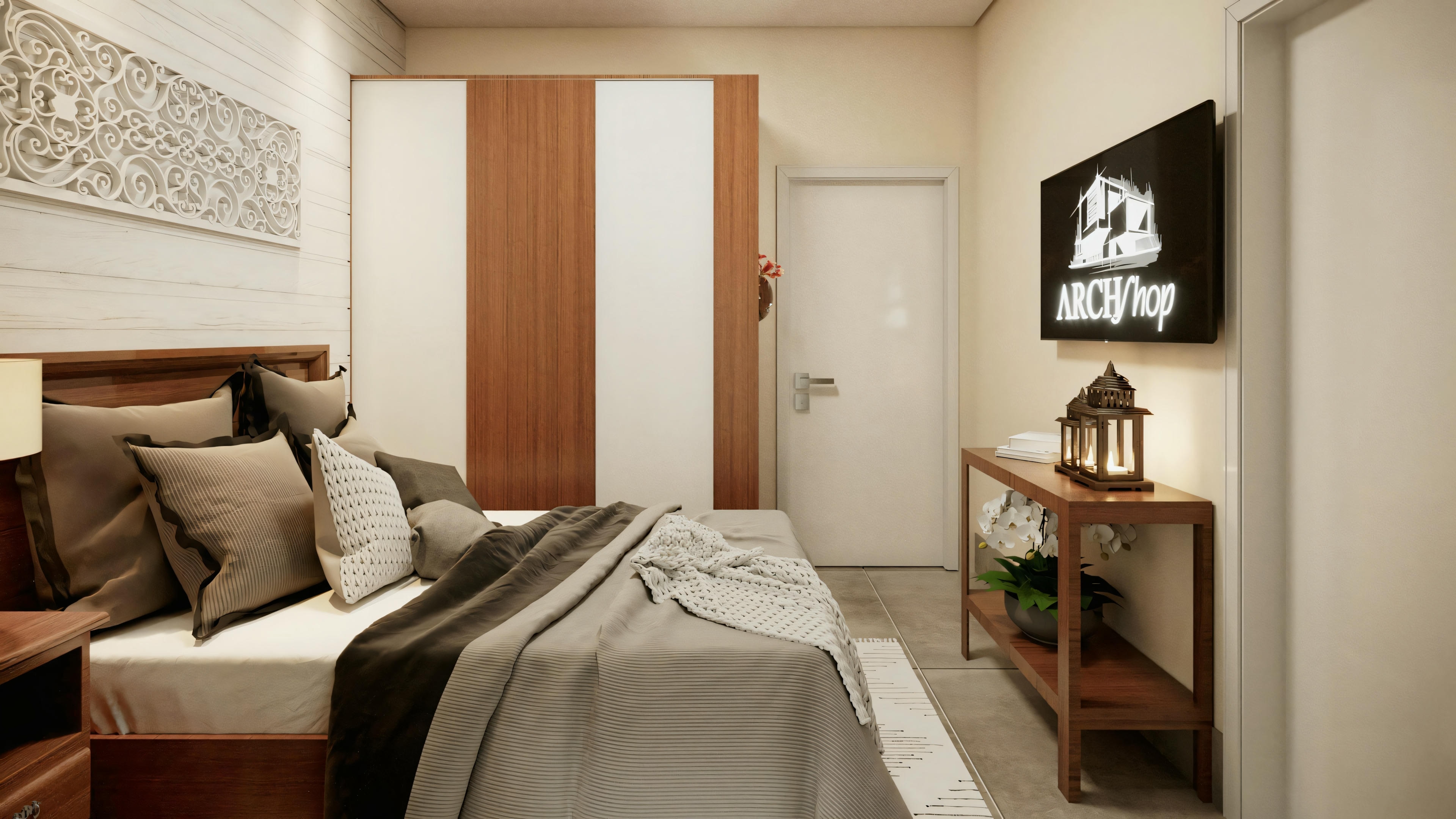 Dormitorio con cama hecha, mesita de noche y pequeña área de trabajo.