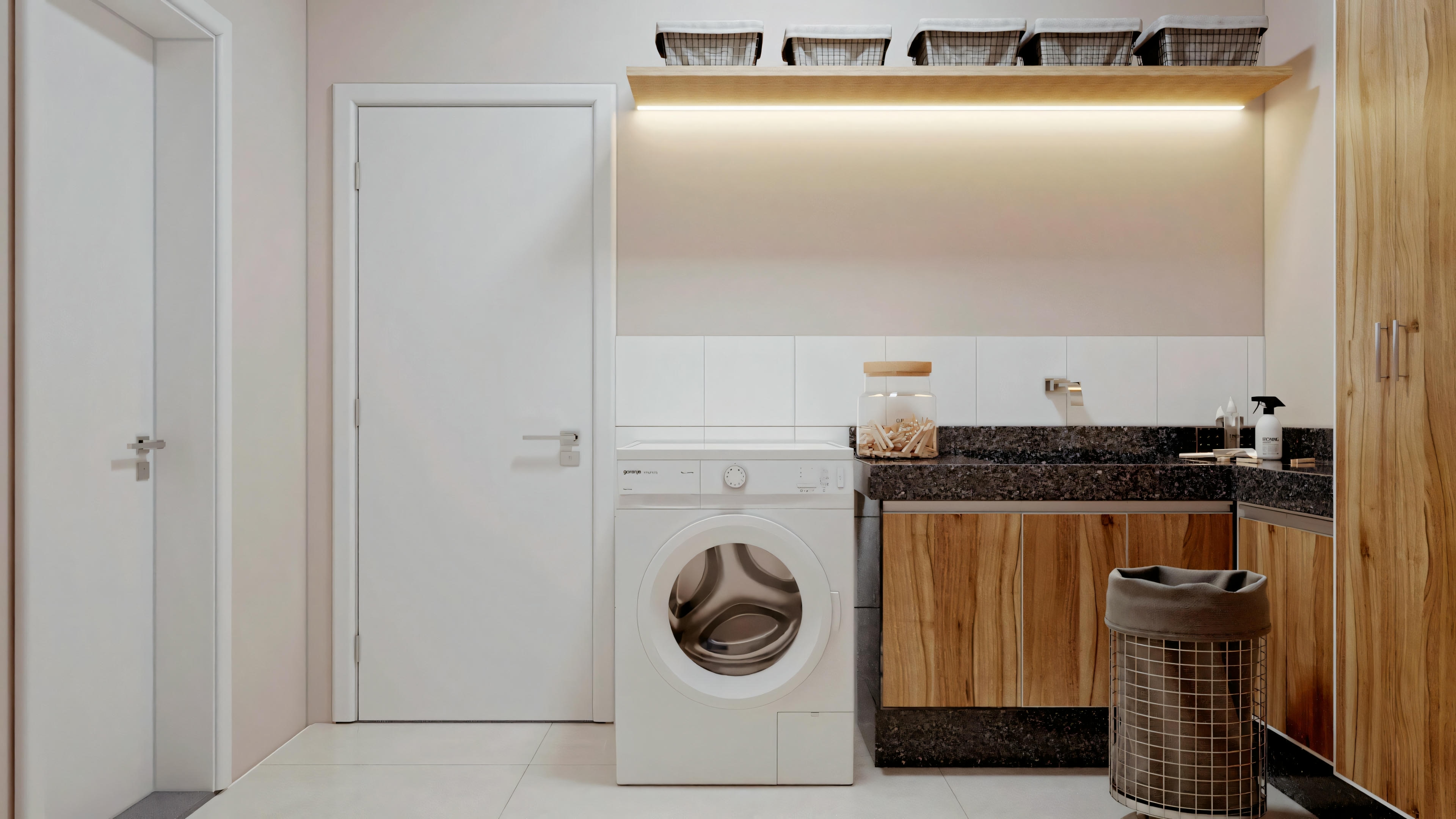 Un espacio compacto de lavadero dentro de una cocina, con armarios blancos, lavadora y encimeras de madera.