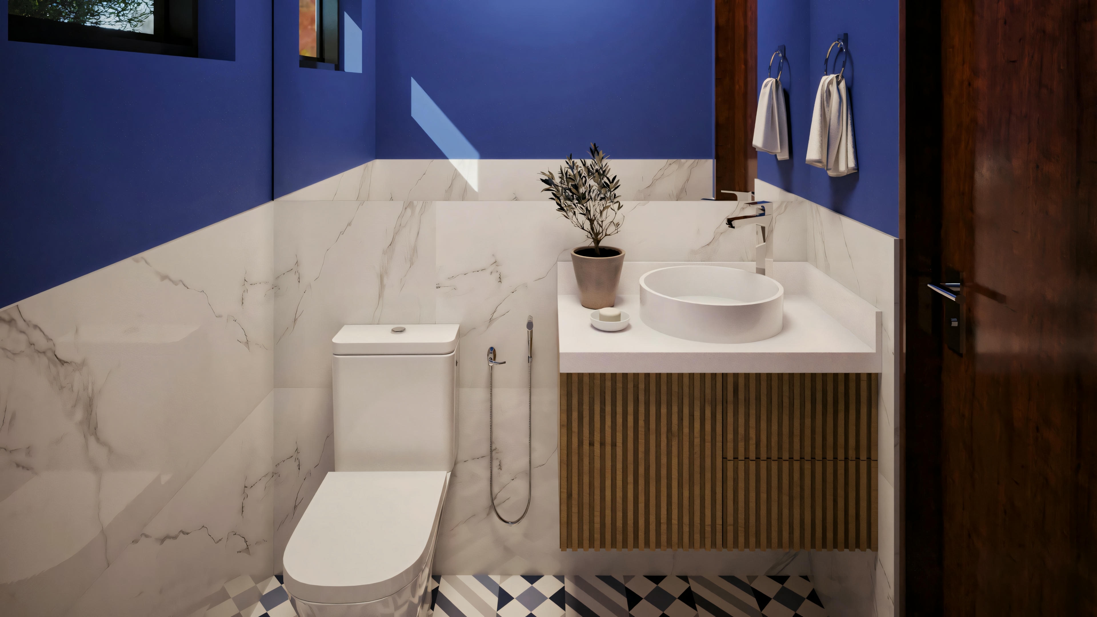 Bathroom with blue walls, toilet, sink with faucet, and a towel hanging next to the sink cabinet.