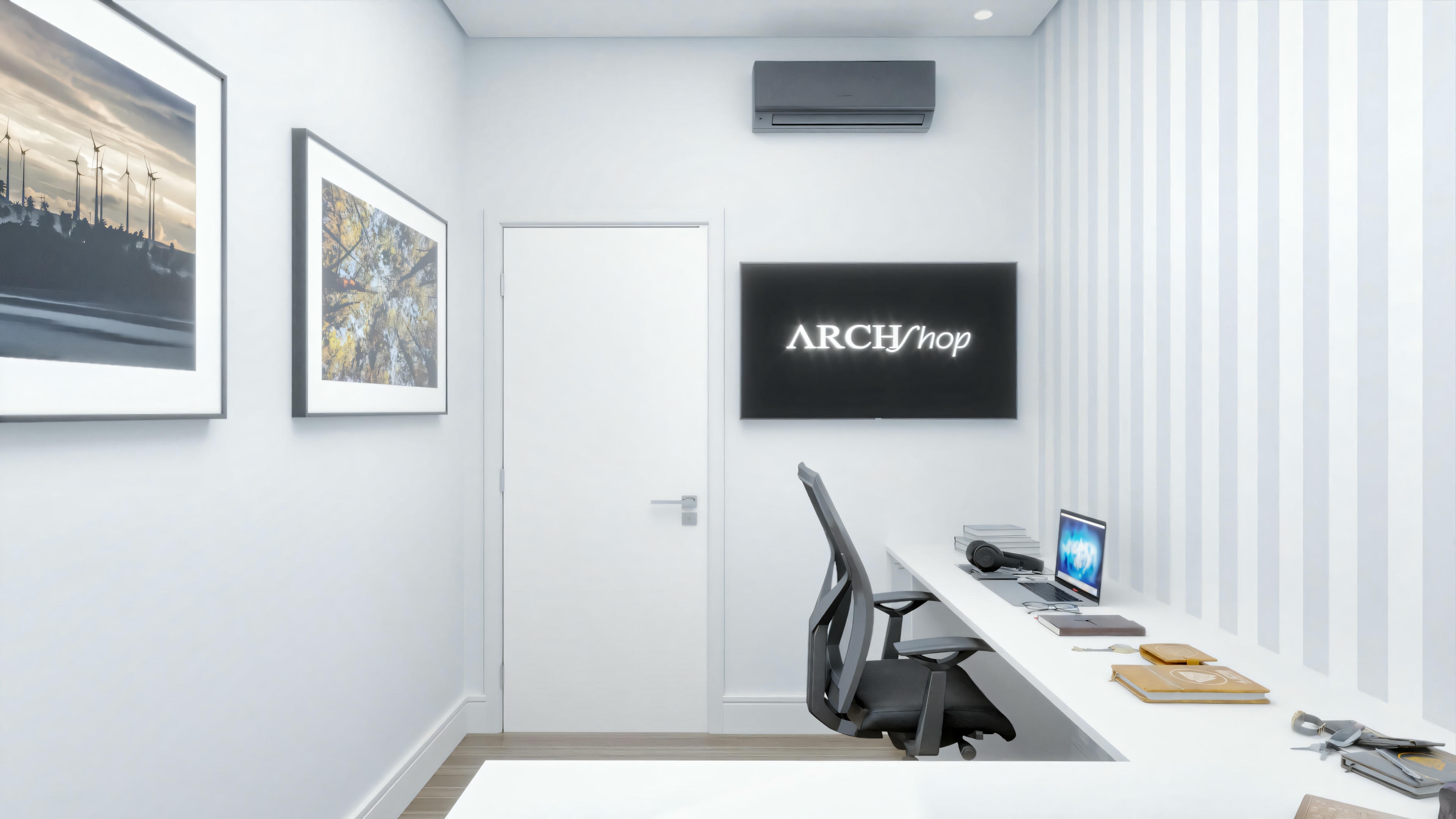 Espacio de oficina con escritorio, silla y cuadros en la pared.
