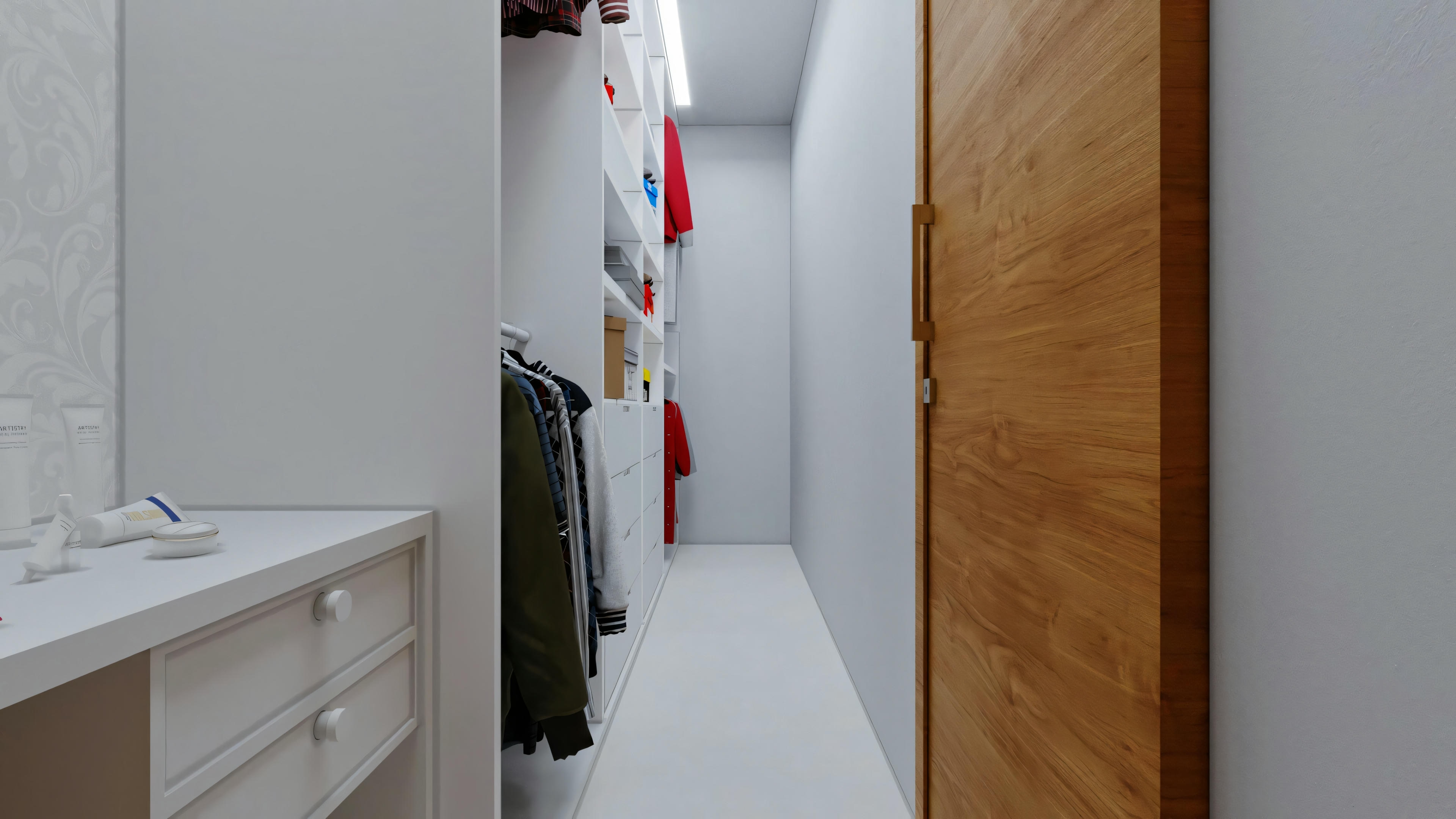Vista opuesta de un pasillo con unidades de almacenamiento blancas a la izquierda y un abrigo colgado al fondo.
