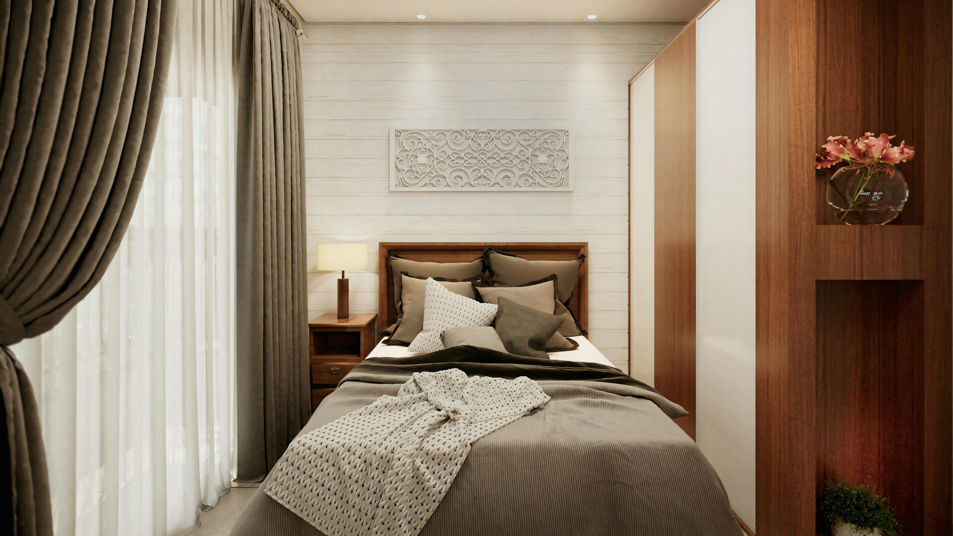 Well-lit bedroom with large bed, pillows, and headboard against the wall. There are curtains on the left and a lamp on the right.