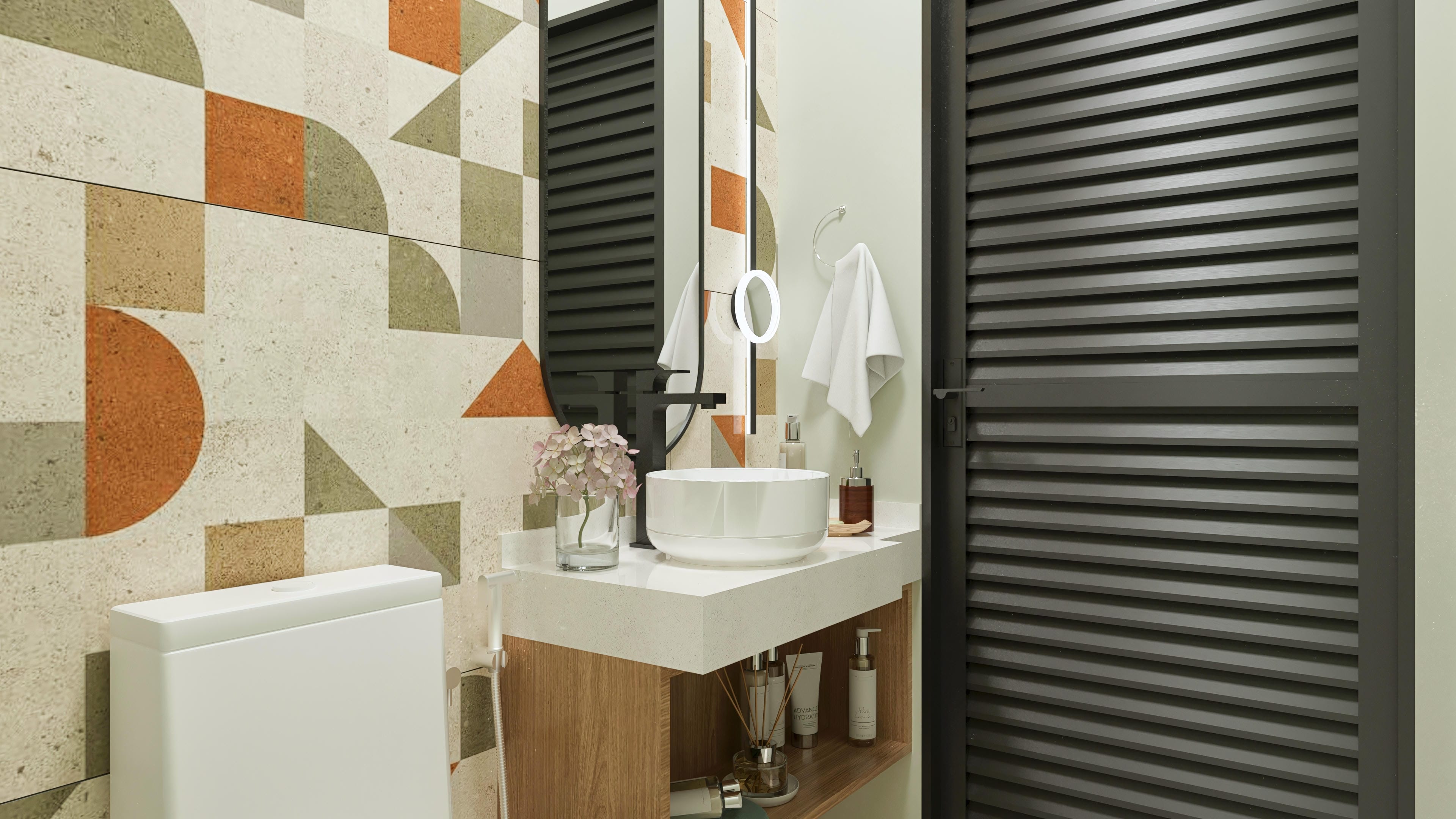 Interior of a modern bathroom with a light stone countertop, white sink, and slatted wood vanity. Highlight for geometric tile with earthy tones and a dark slatted door.