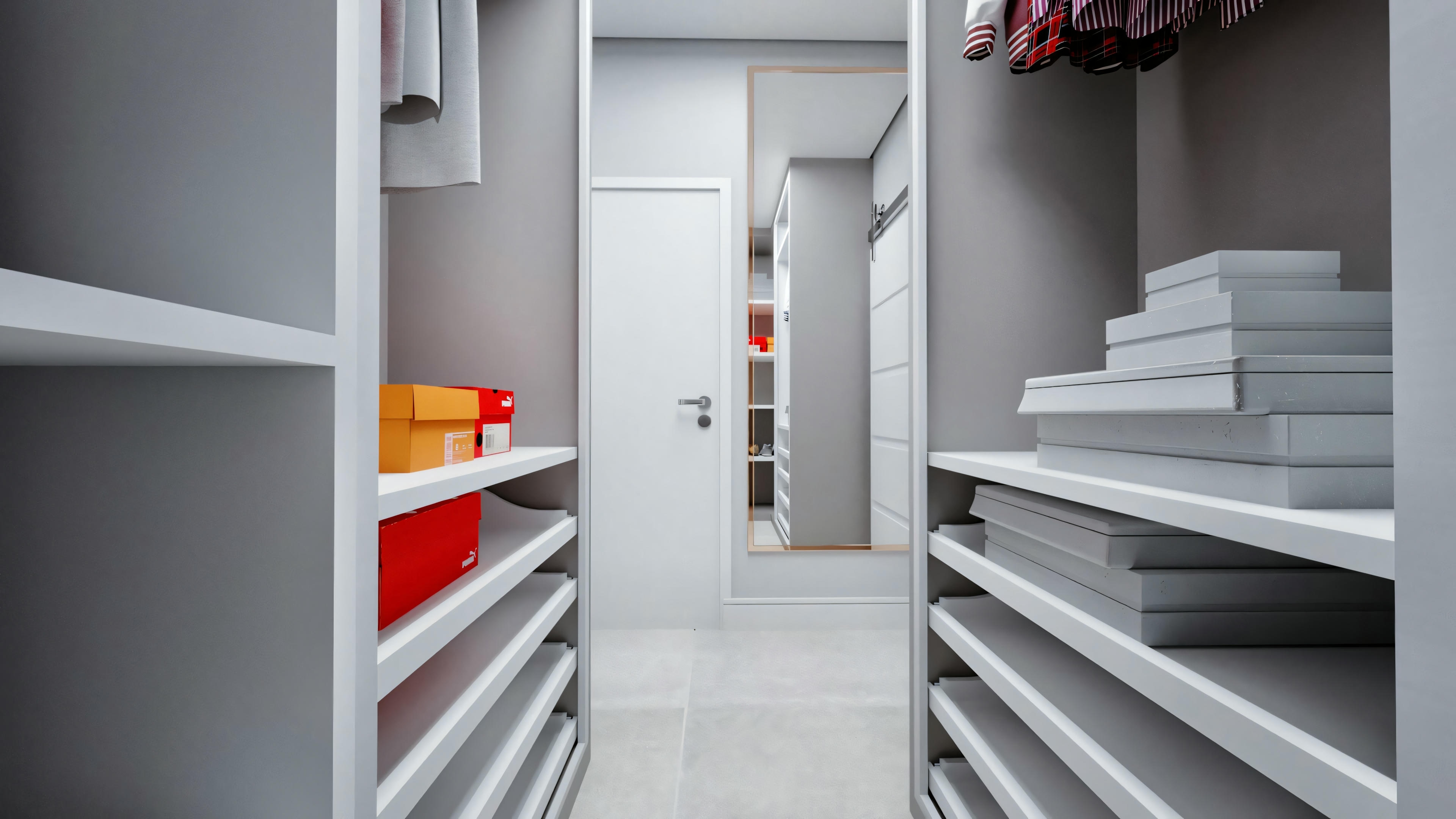 A modern, well-organized closet with various shelves containing folded clothes and storage boxes.