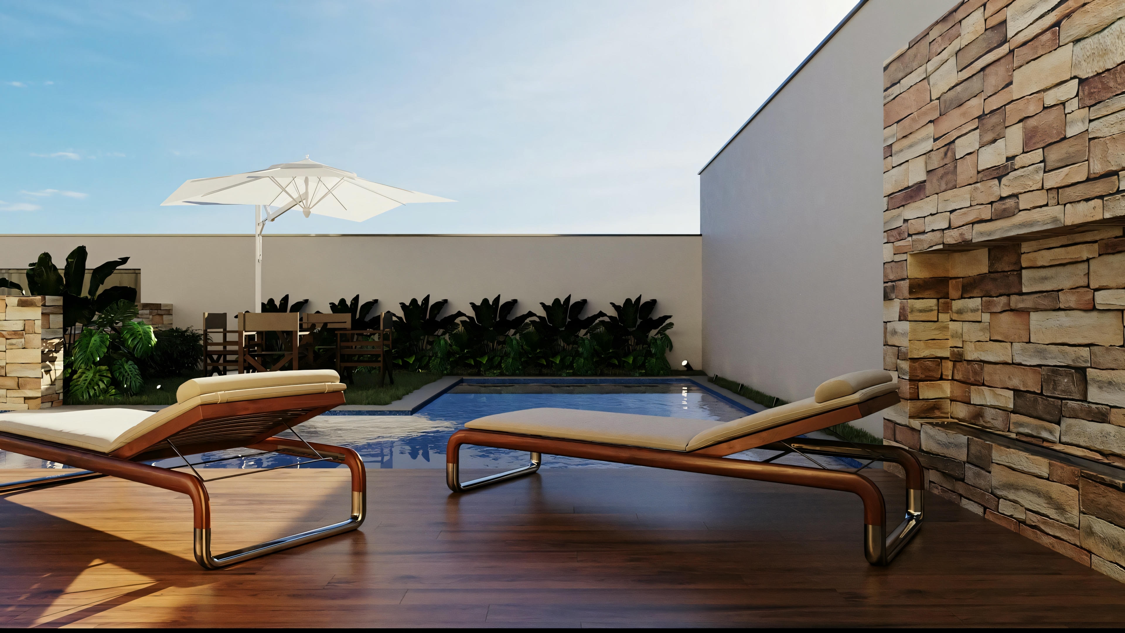 Outdoor area with two wooden lounge chairs on a tiled floor. A well-built stone wall is prominent in the foreground, while in the background there is a view of distant mountains beyond the property boundaries.