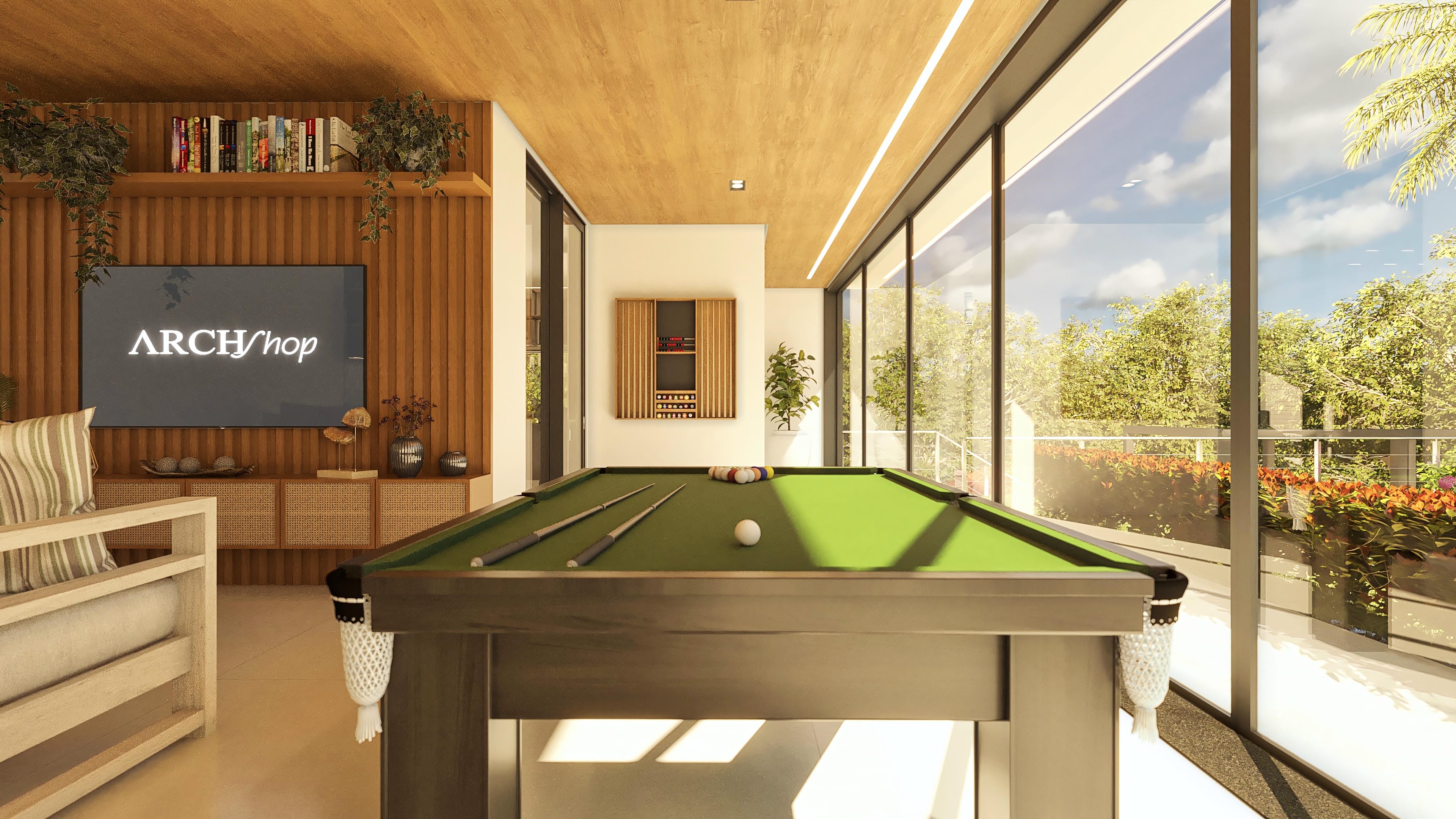 Interior de sala de juegos con mesa de billar, mobiliario moderno de madera y amplios ventanales de vidrio con vistas a la zona exterior arbolada y piscina.