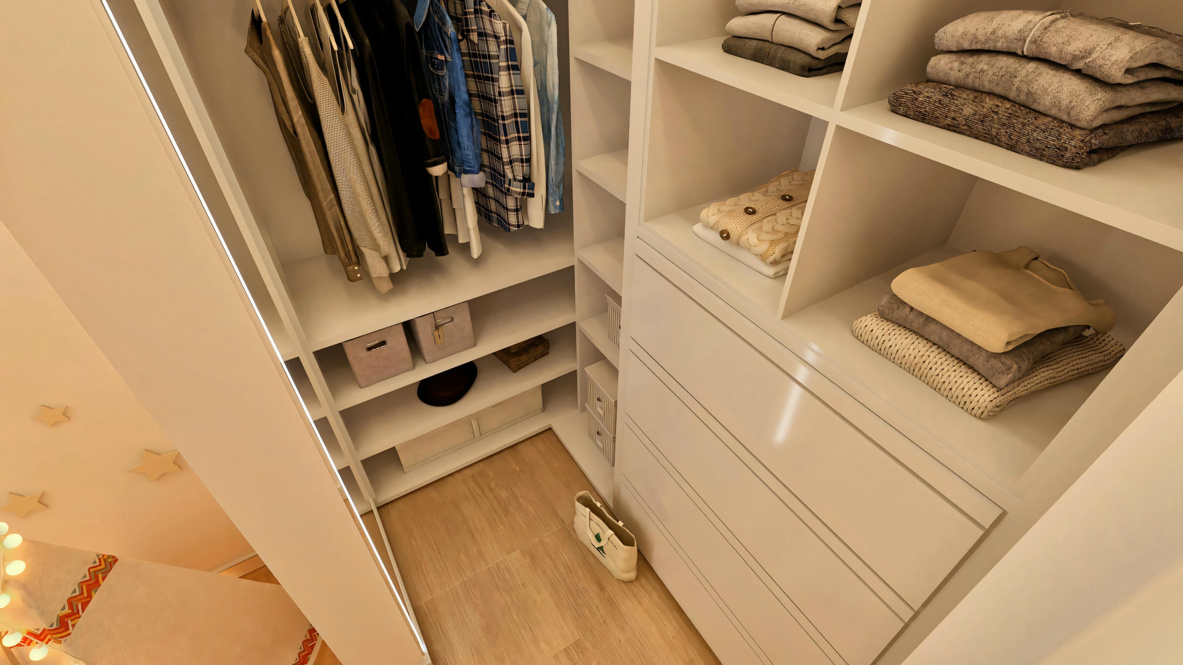 Top view of the walk-in closet in the girls' suite in a luxury house, showing custom cabinets, drawers, and wooden flooring.