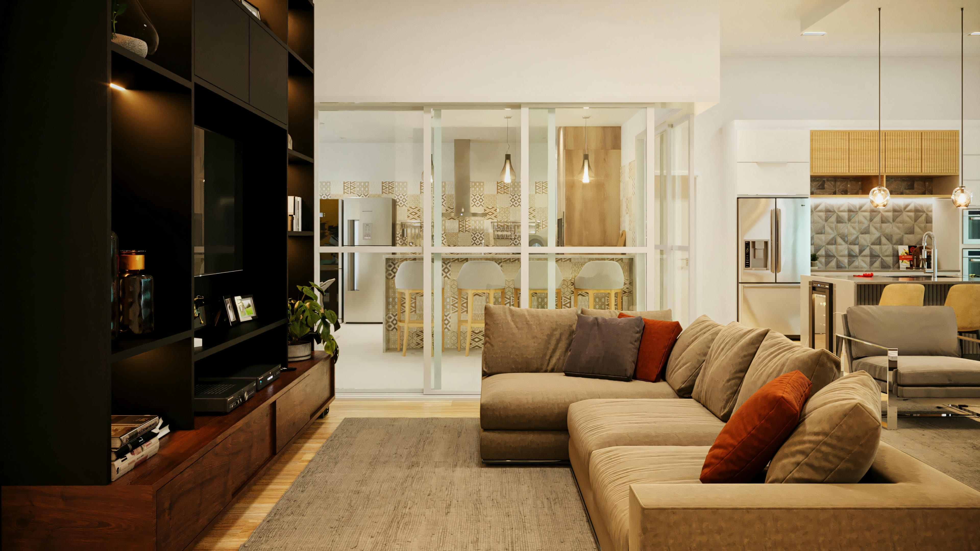 Sala de TV com sofá em L, painel de TV, e portas de correr em vidro que integram com a cozinha gourmet com ilha, em casa com 3 suítes.