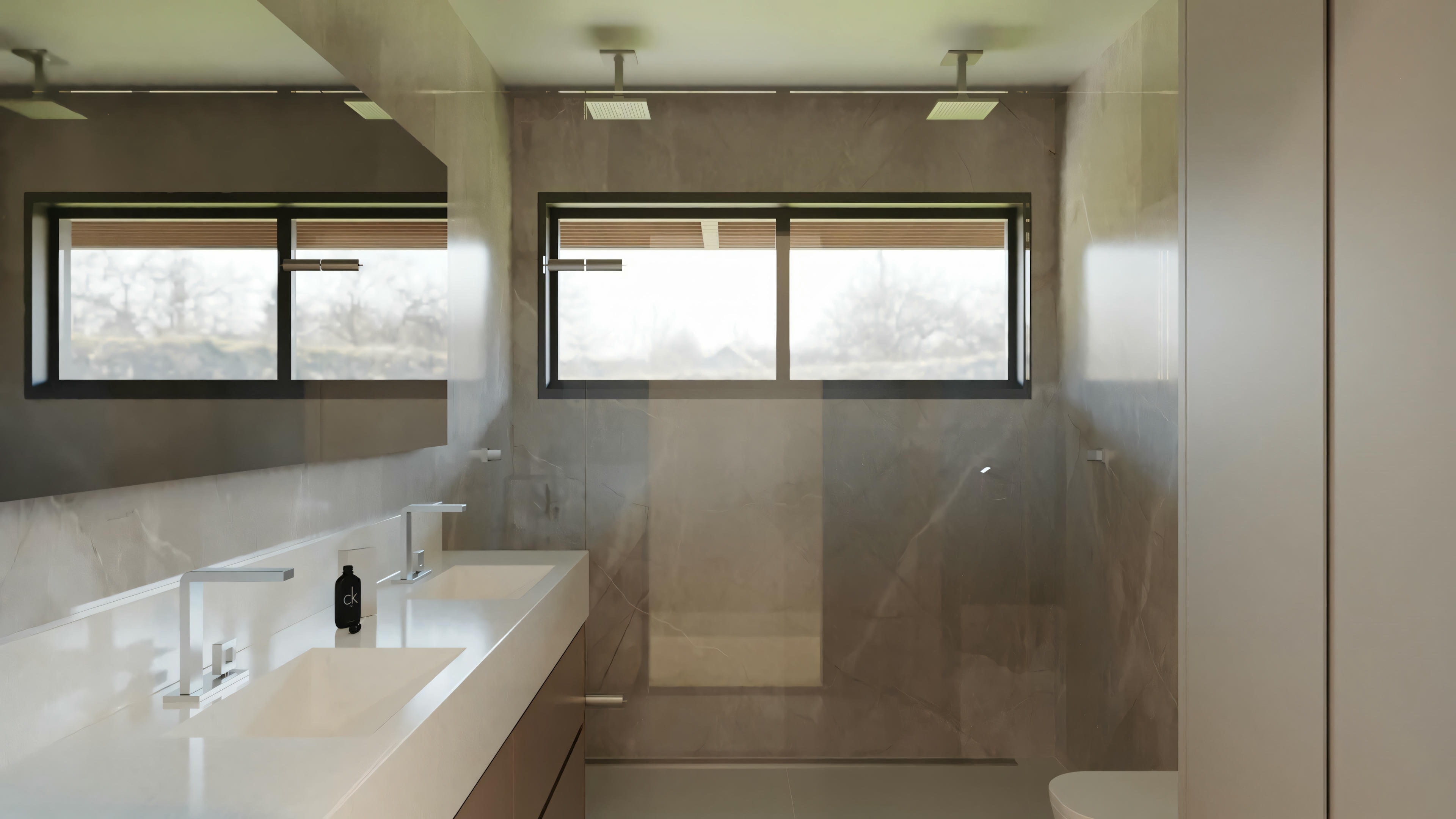 A modern bathroom with a large mirror, two sinks, and a spacious countertop, with large windows in the background allowing natural light.