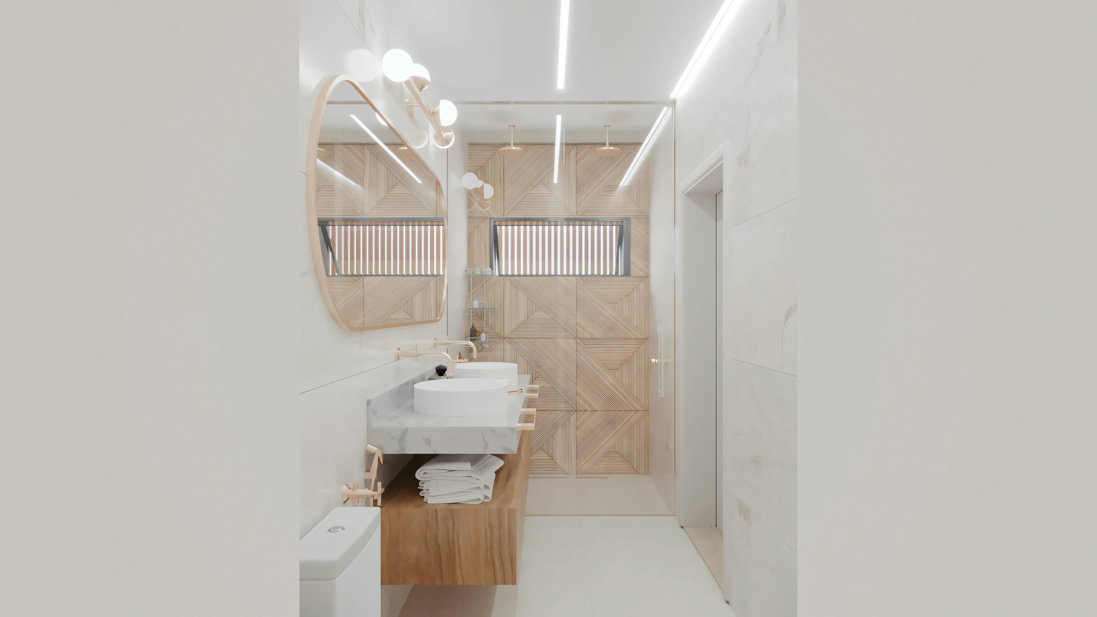 Un baño con inodoro a la derecha, lavabo central y área de ducha con puertas de vidrio al fondo. Las paredes están revestidas con azulejos beige y hay estantes sobre el inodoro.