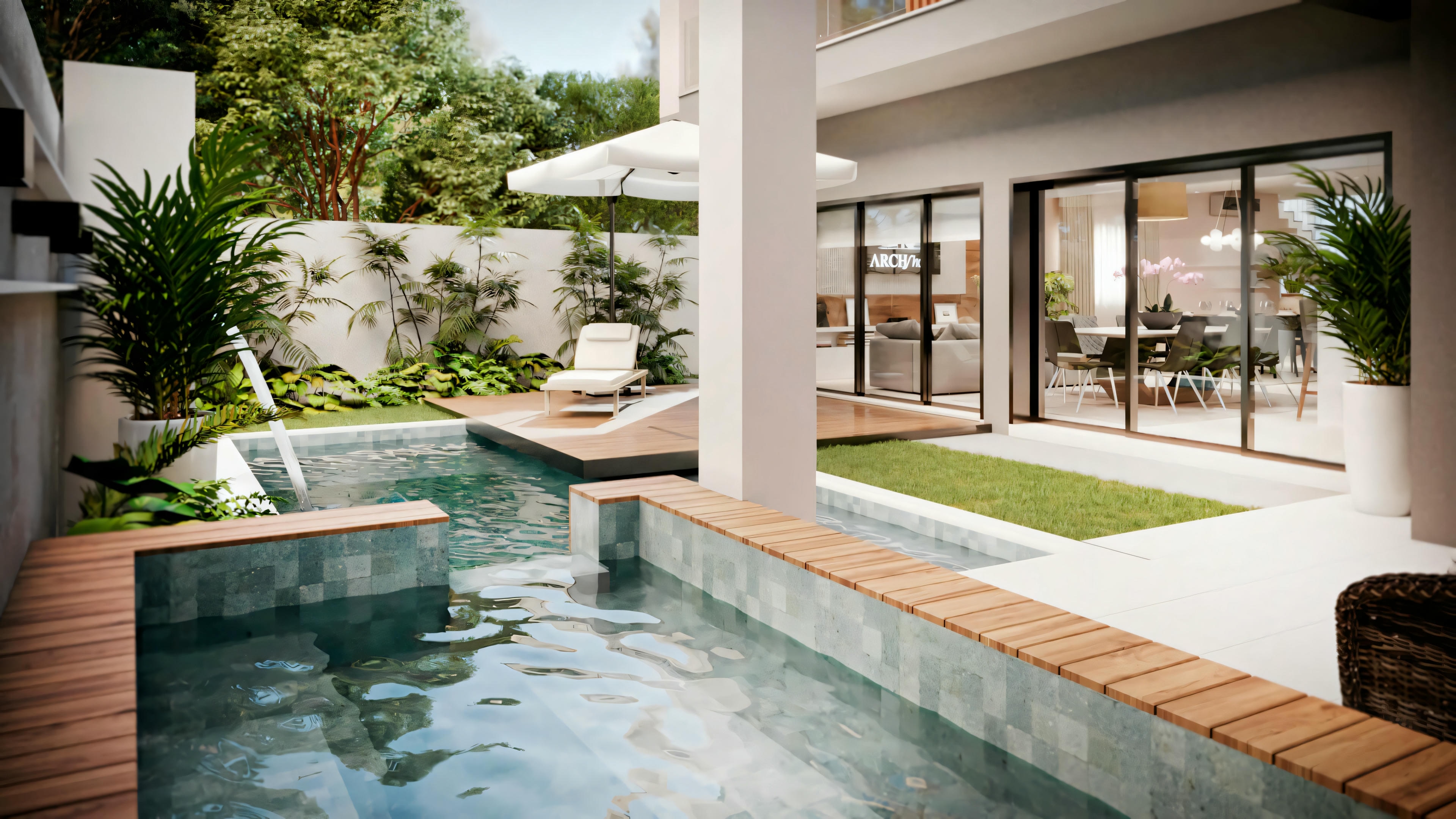 Outdoor pool area with lounge chairs and surrounding plants.