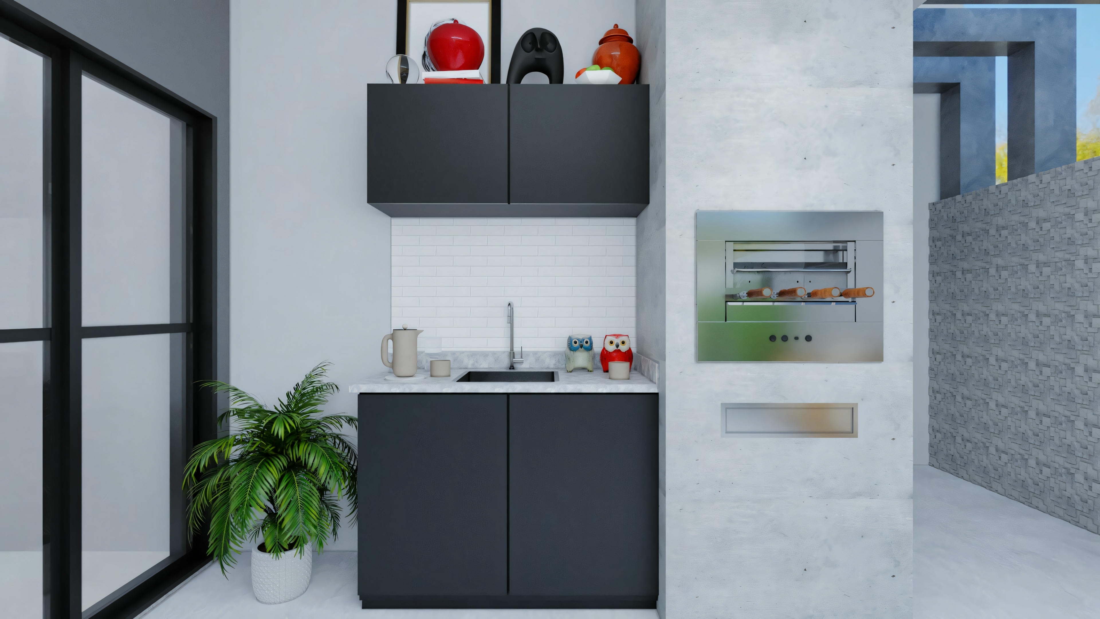 A kitchen with black cabinets, white countertops, and red decorative items above the cabinets.