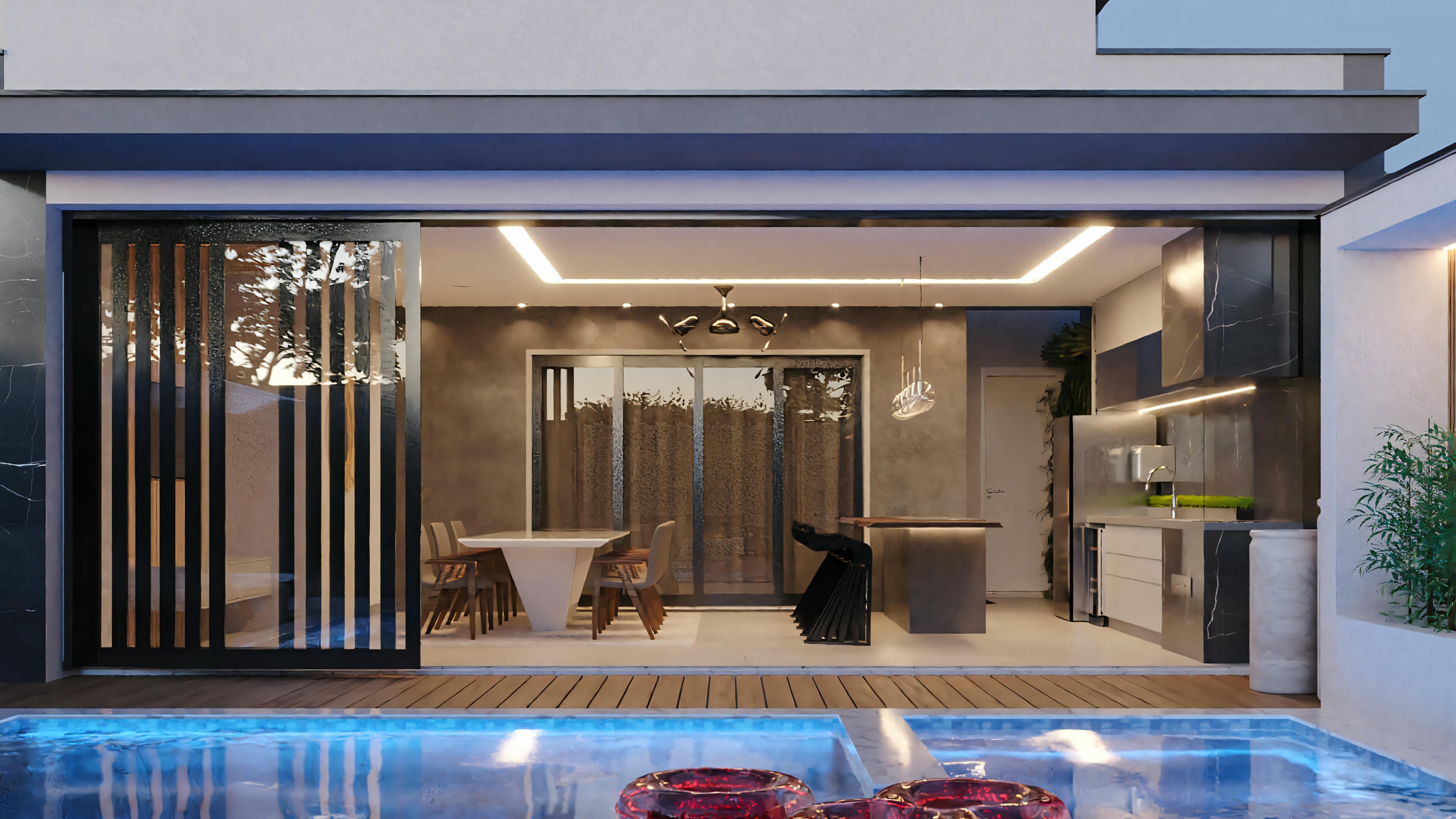 A house with an open patio area, seating, and transparent sliding doors leading to the interior.