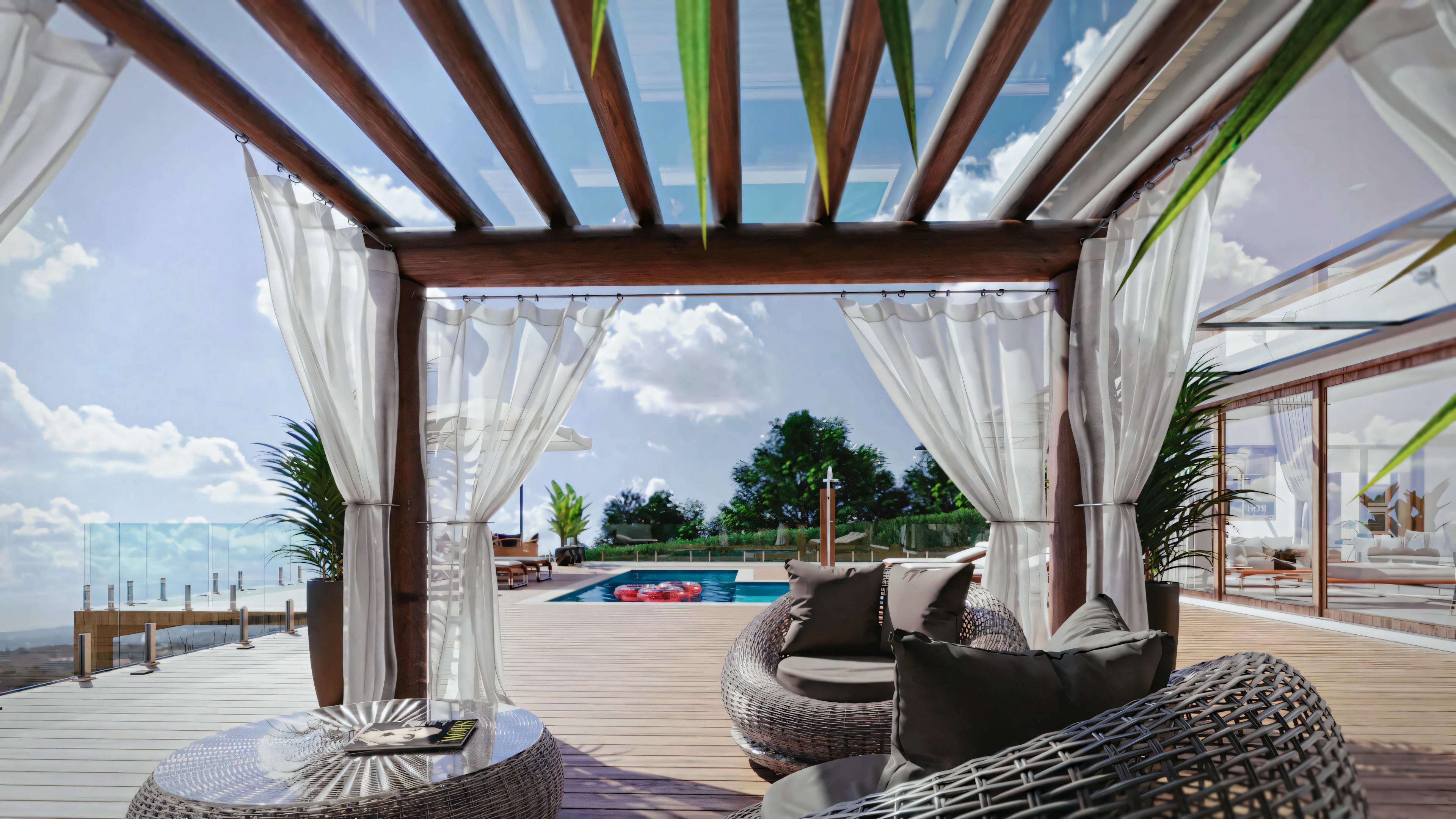 Outdoor patio area overlooking a beach, featuring comfortable seating under a striped awning.