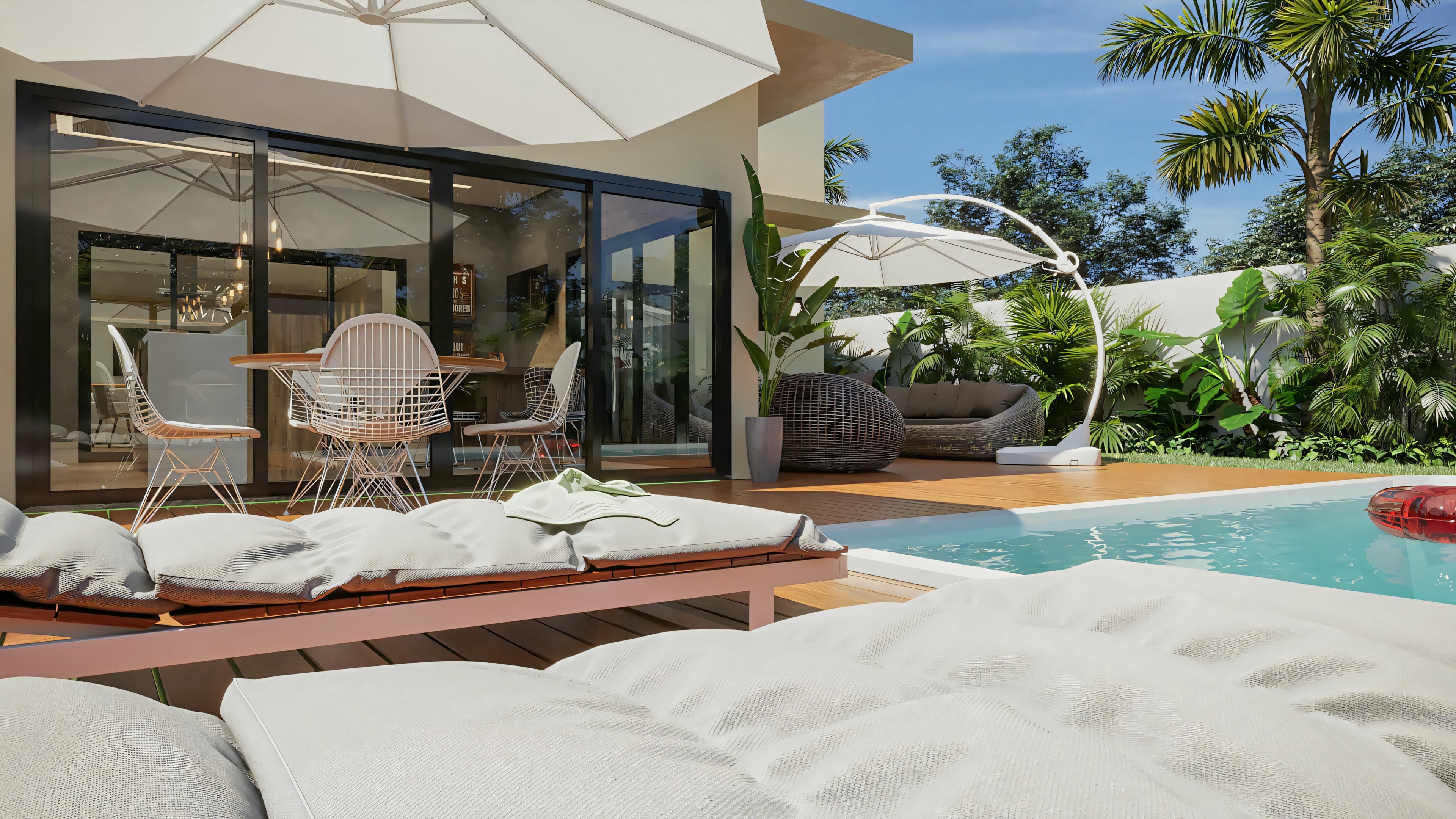 View of the leisure area with pool and deck in the ready-made single-story house project with 2 suites and gourmet area. Shows the lounge chairs, pool, outdoor living area with sofa and umbrella, and the integration with the internal gourmet area through sliding glass doors.