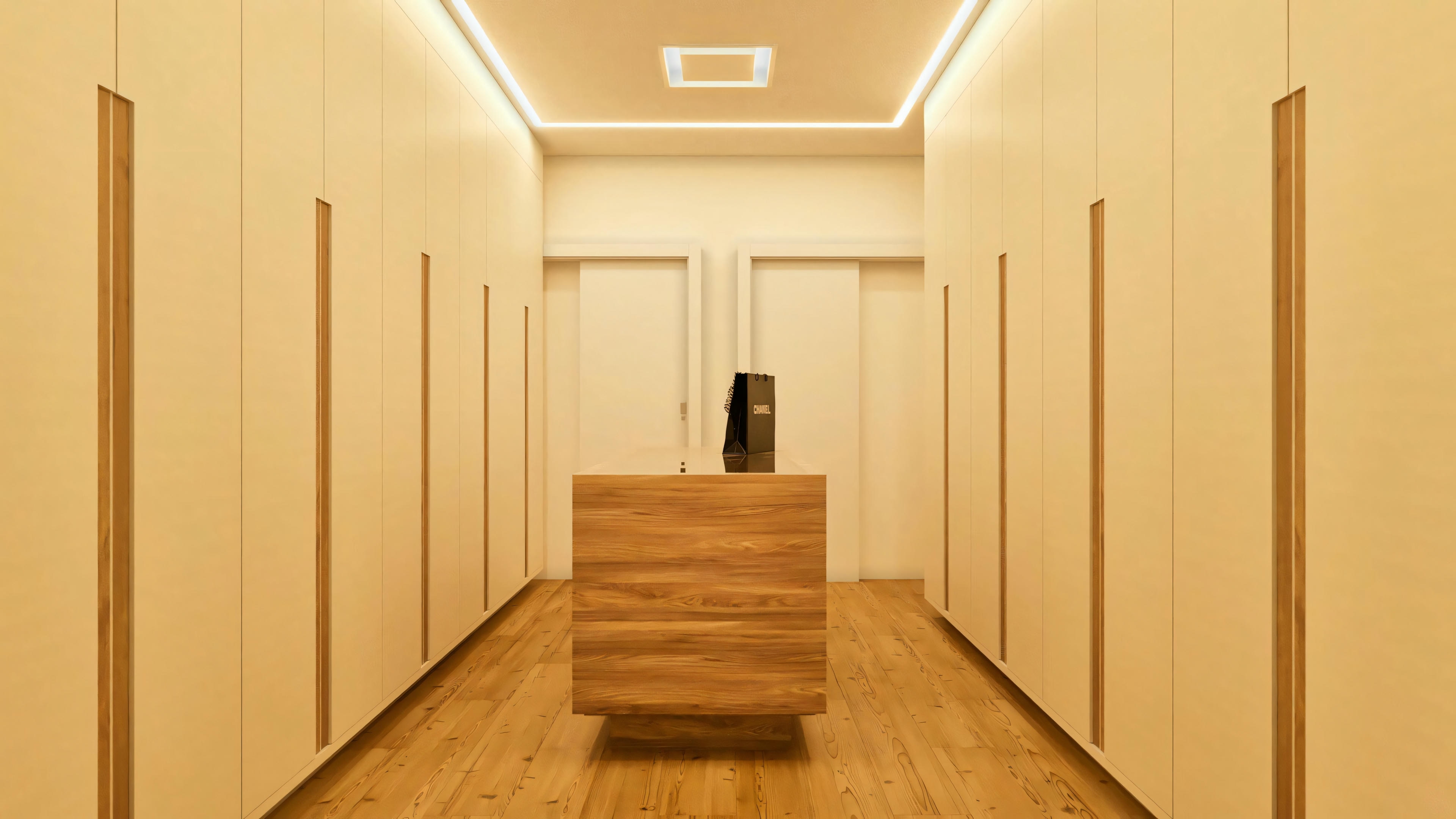 Vestidor espacioso de la suite principal en el proyecto arquitectónico de la casa de dos pisos de 330m², con armarios planeados del suelo al techo en ambos lados con puertas claras y detalles en madera, isla central de madera, piso de madera e iluminación LED empotrada en el falso techo. Dos puertas blancas al fondo.