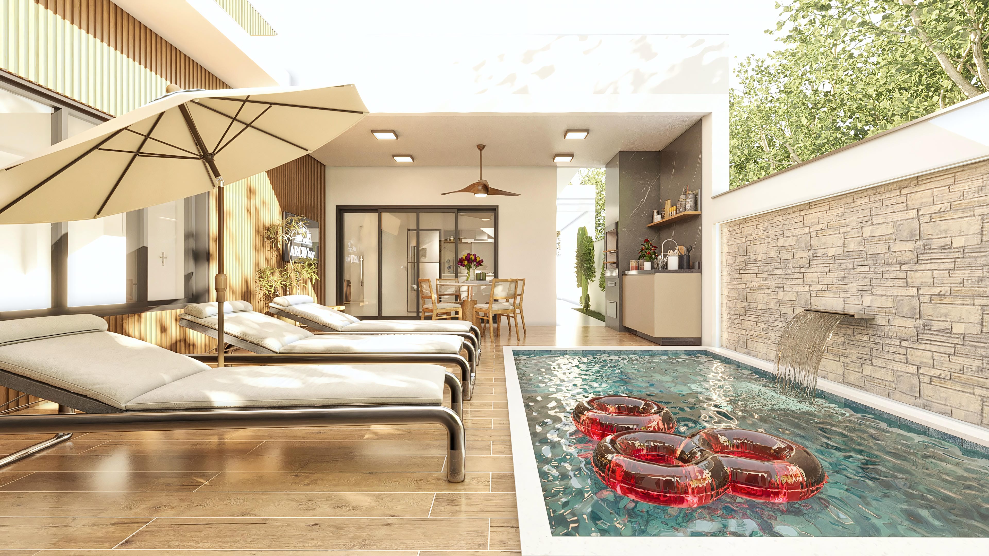 Outdoor area with an infinity pool, stone waterfall, sun loungers, and integrated gourmet area, reflecting the modern architecture of the house.