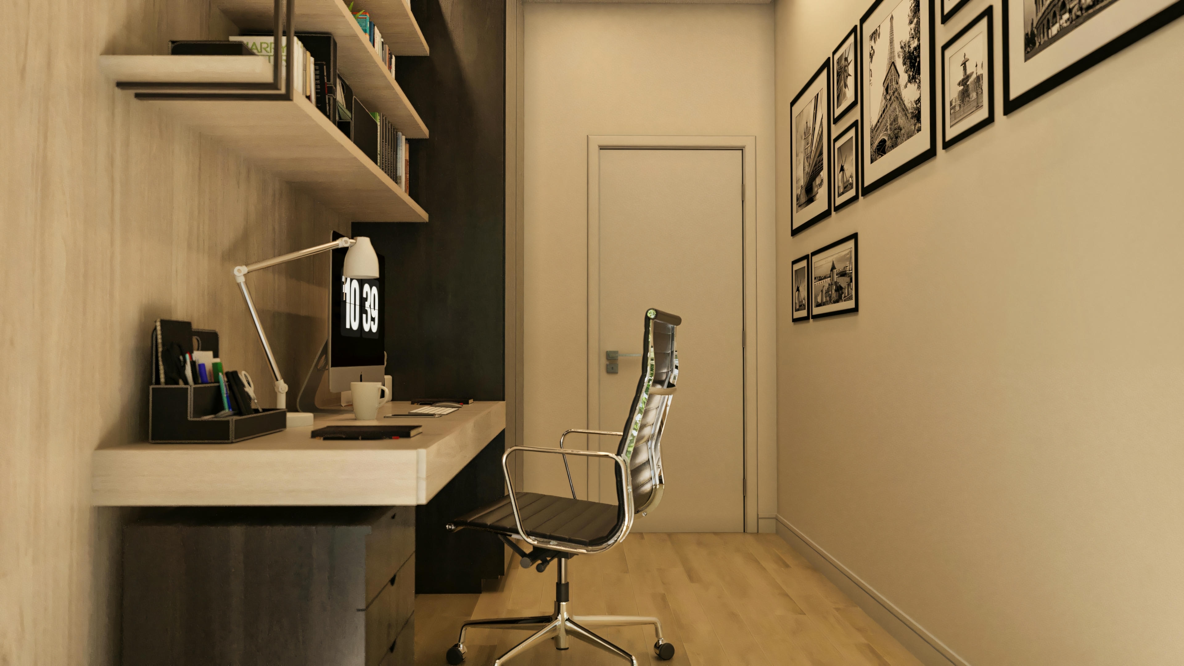 Side view of the office in a high-standard 5-suite house, showing the desk, chair, and wall decorated with black and white paintings.