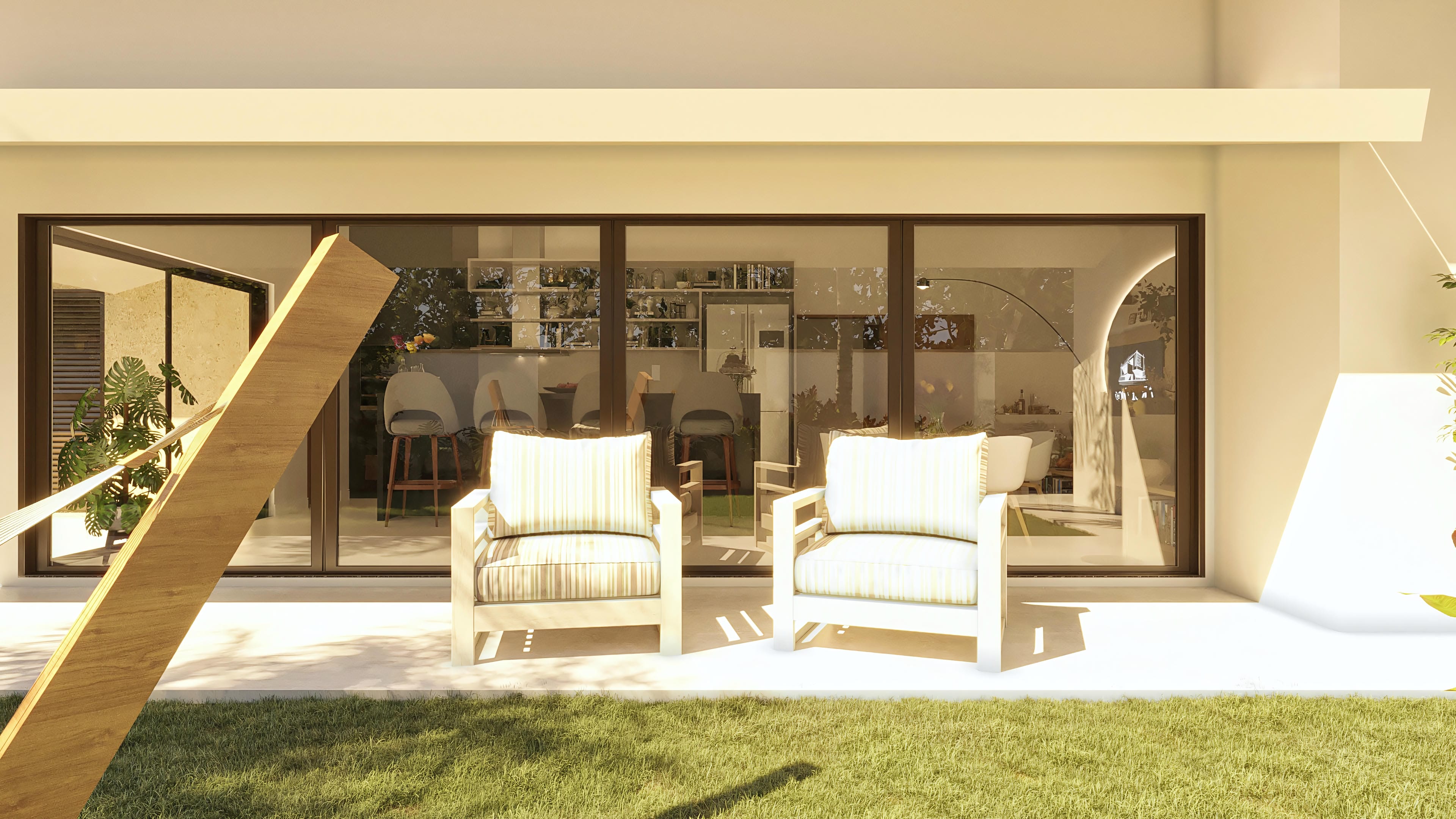 View of the outdoor leisure area of a modern single-story house, with large glass doors connecting to the interior, where the gourmet kitchen and living room are seen.