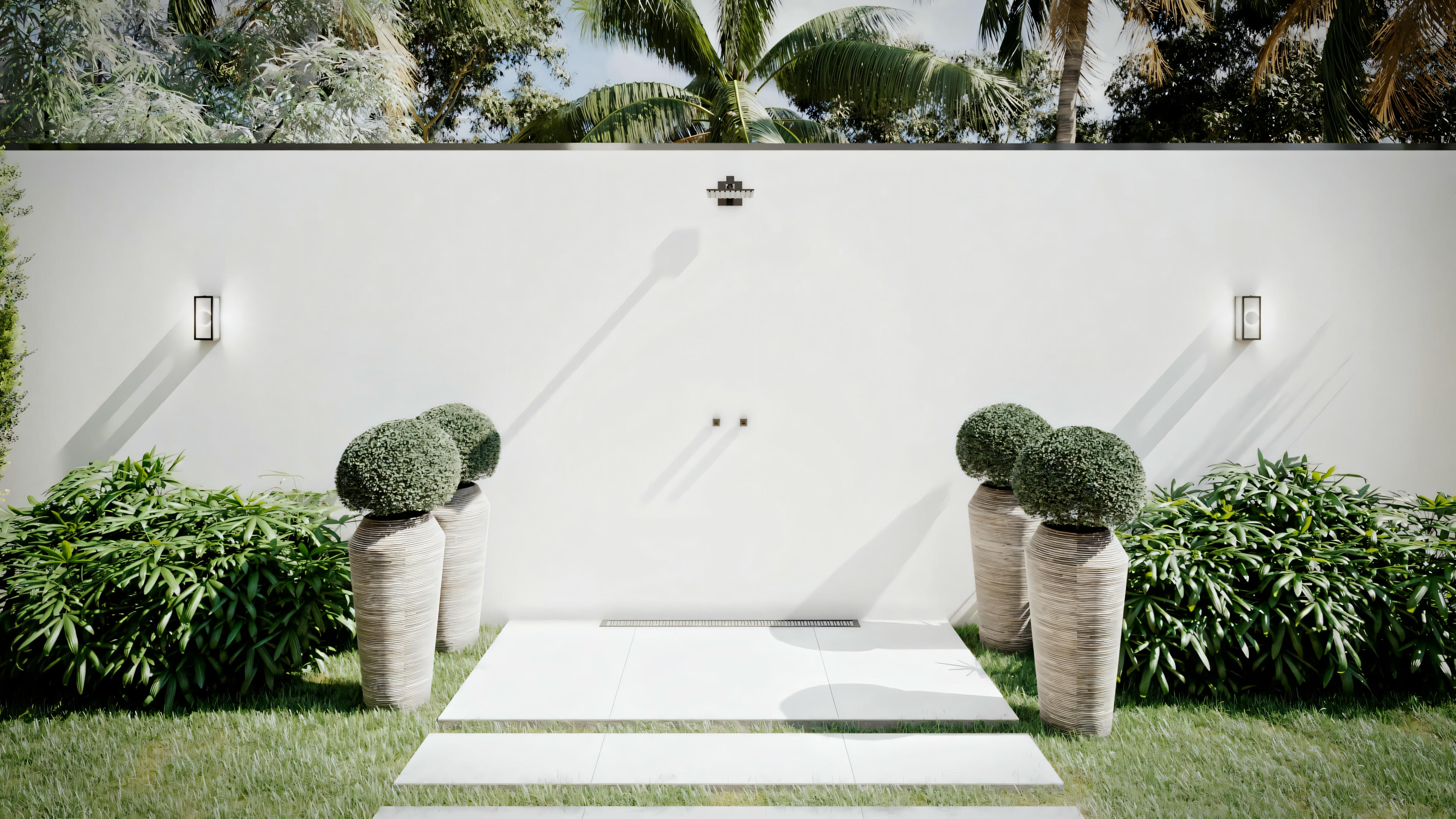 Outdoor space with a white bench, stairs leading to a platform, and potted plants against a white wall.