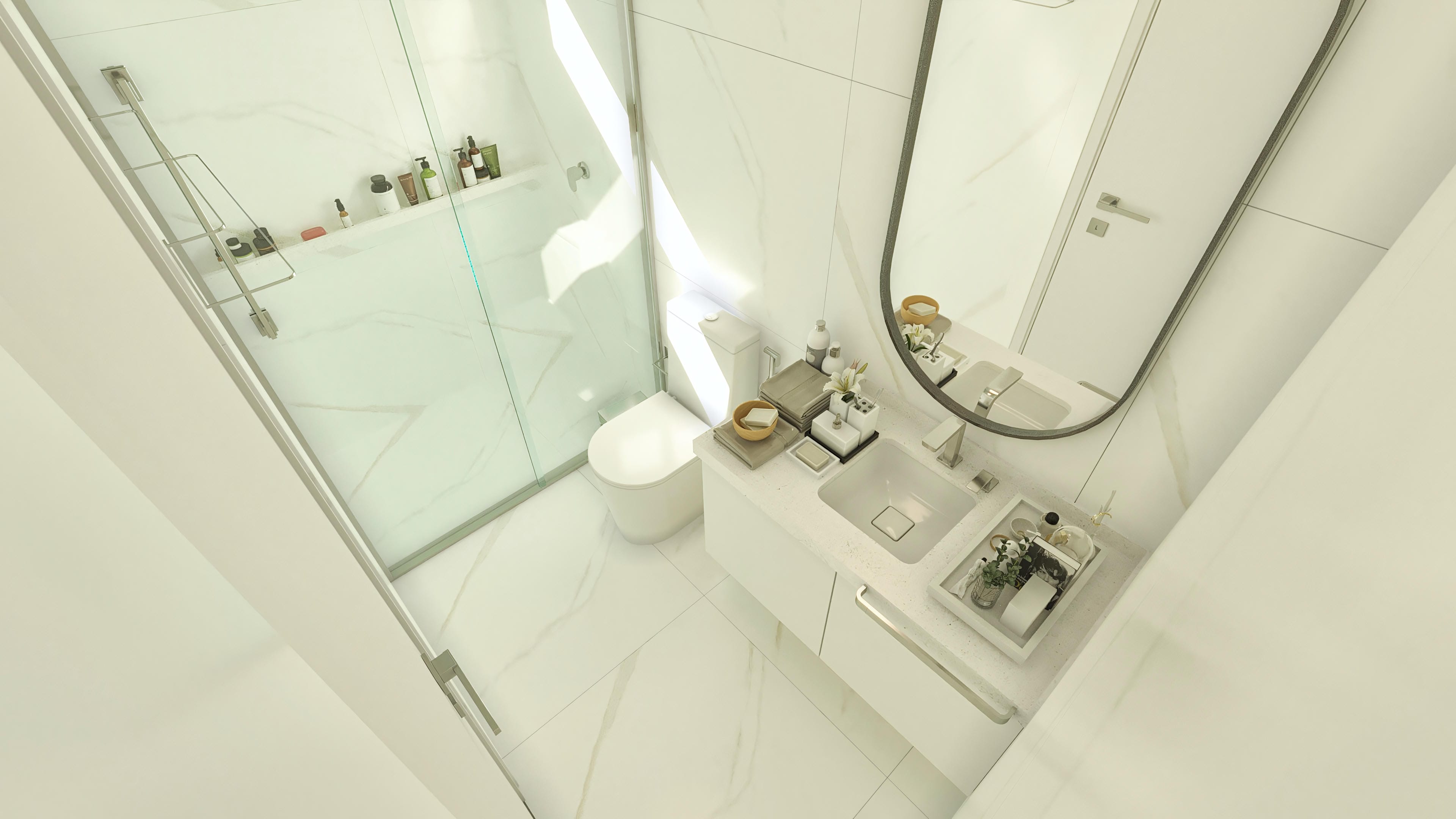 Visión detallada de un baño moderno con encimera doble, espejo ovalado y mampara de cristal. Revestimiento en porcelanato marmorizado y loza limpia.