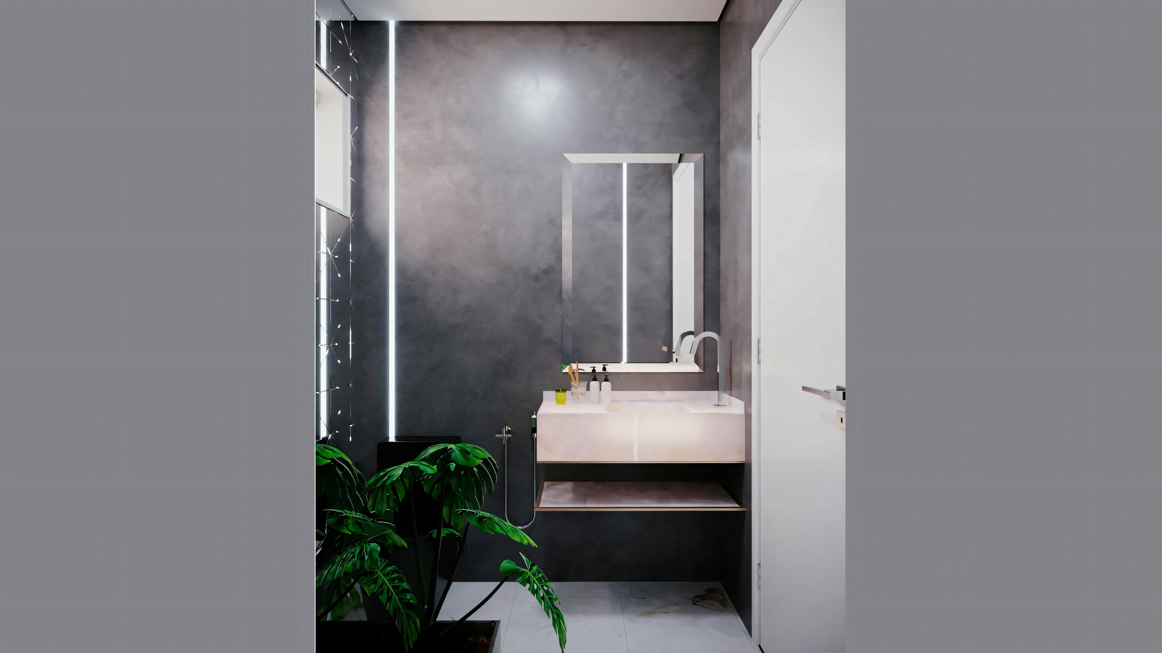 A modern bathroom with a large green plant, sink with mirror, and shower area partially obscured by steam.