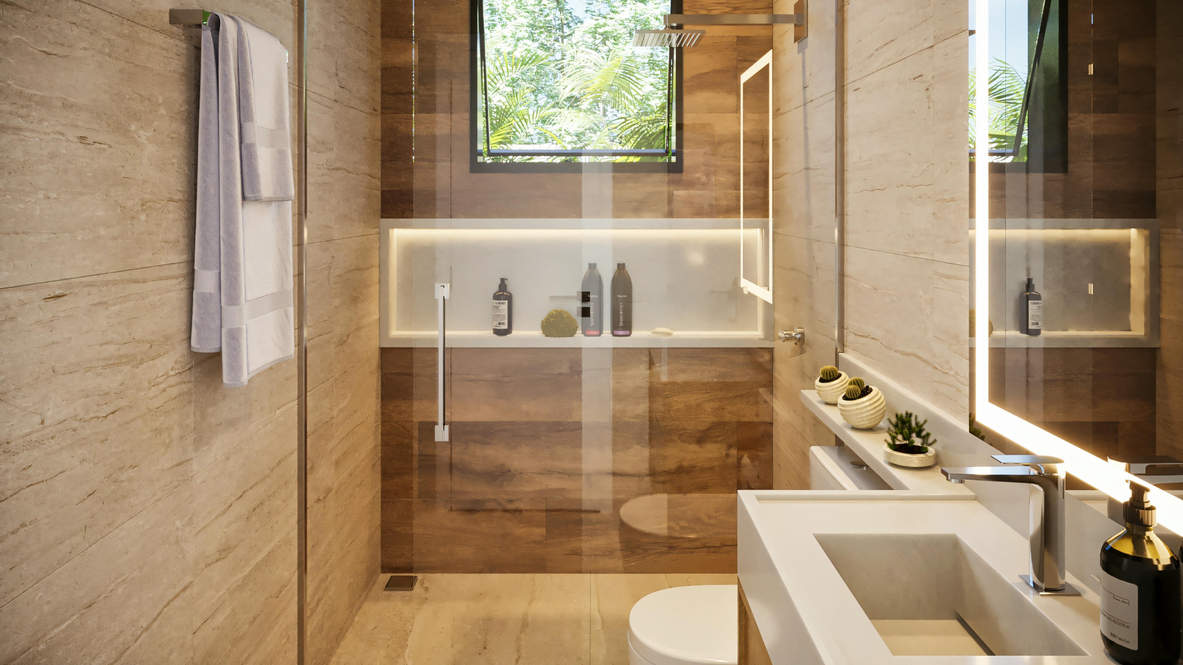 Baño de una suite en casa de planta baja con 3 suites, presentando revestimientos en tonos neutros, box con nicho iluminado, encimera moderna y espejo con iluminación LED.