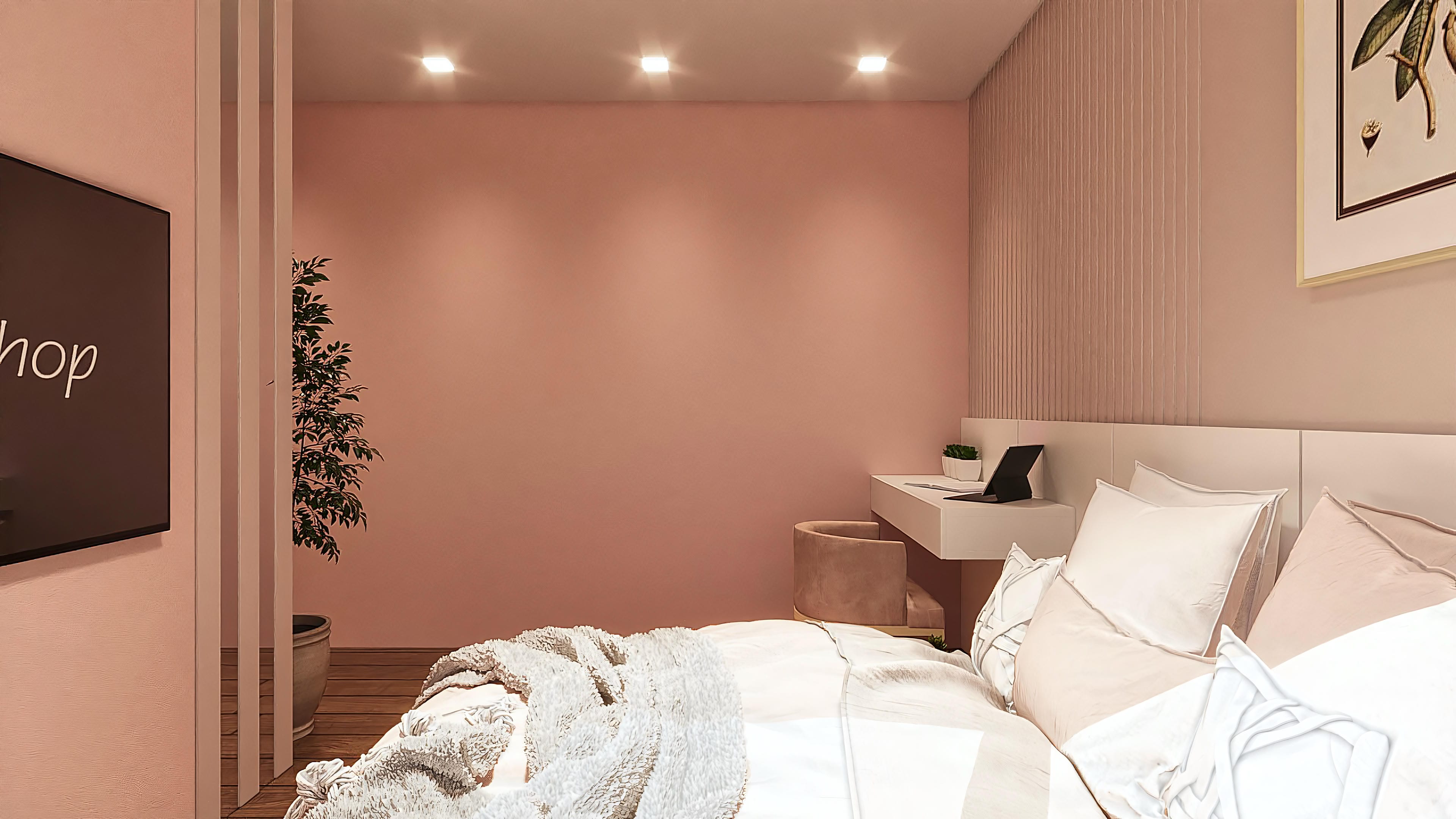 Interior de habitación con paredes en tono rosa pálido, destacando una cama cómoda, una moderna oficina con detalles en blanco y una planta decorativa.