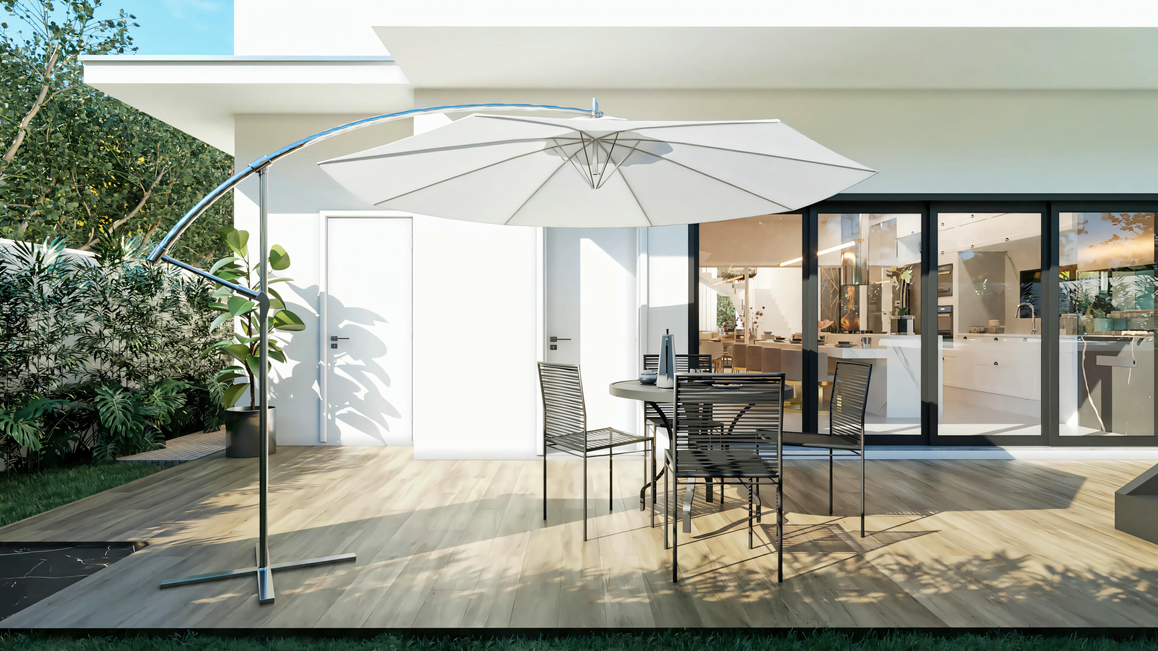 Outdoor patio of a luxury residential project with a wooden deck floor, modern design table and chairs set under a side umbrella, with large glass doors connecting to the interior of the 4-suite house.