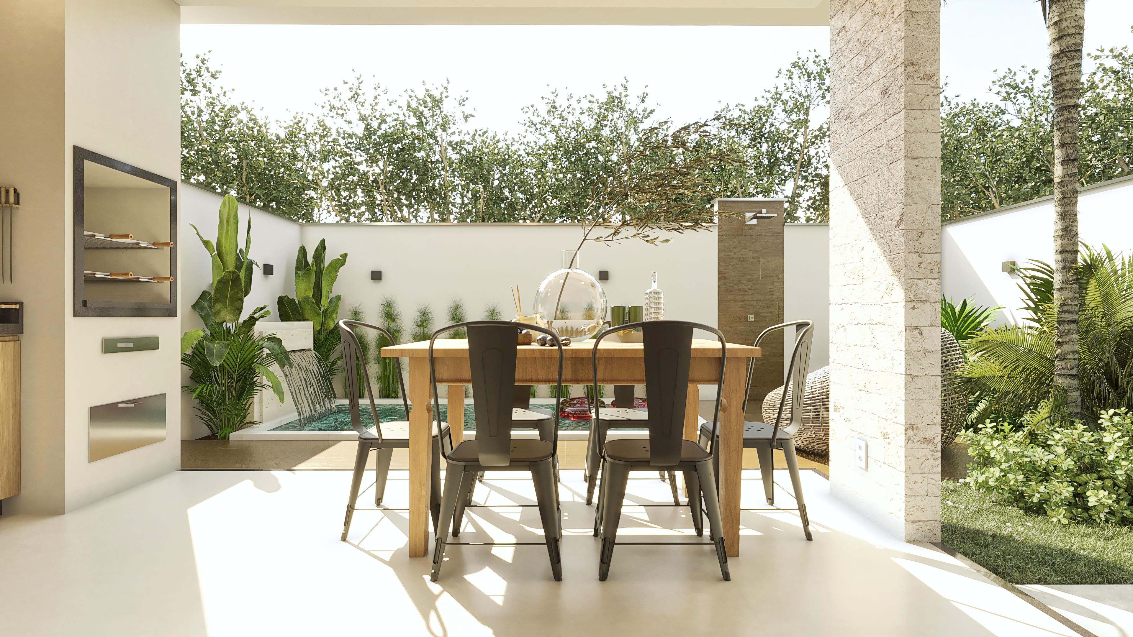 Vista del área gourmet con mesa de comedor, sillas metálicas, piscina con cascada y paisajismo exuberante.