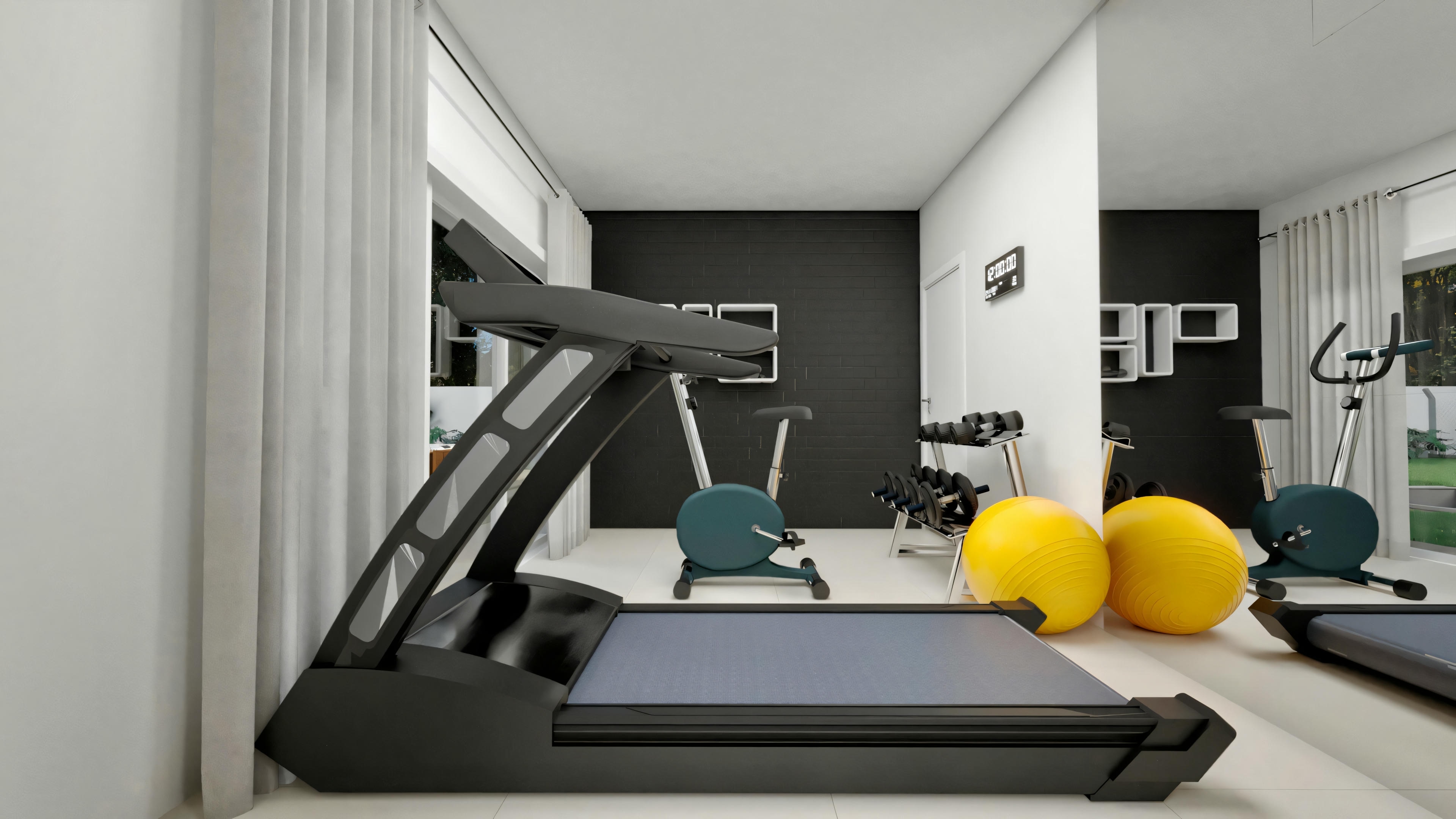 View of the residential gym from the window, showing a treadmill in the foreground, exercise bike, dumbbells, exercise balls, dark textured wall in the background, and a large mirror reflecting the equipment.