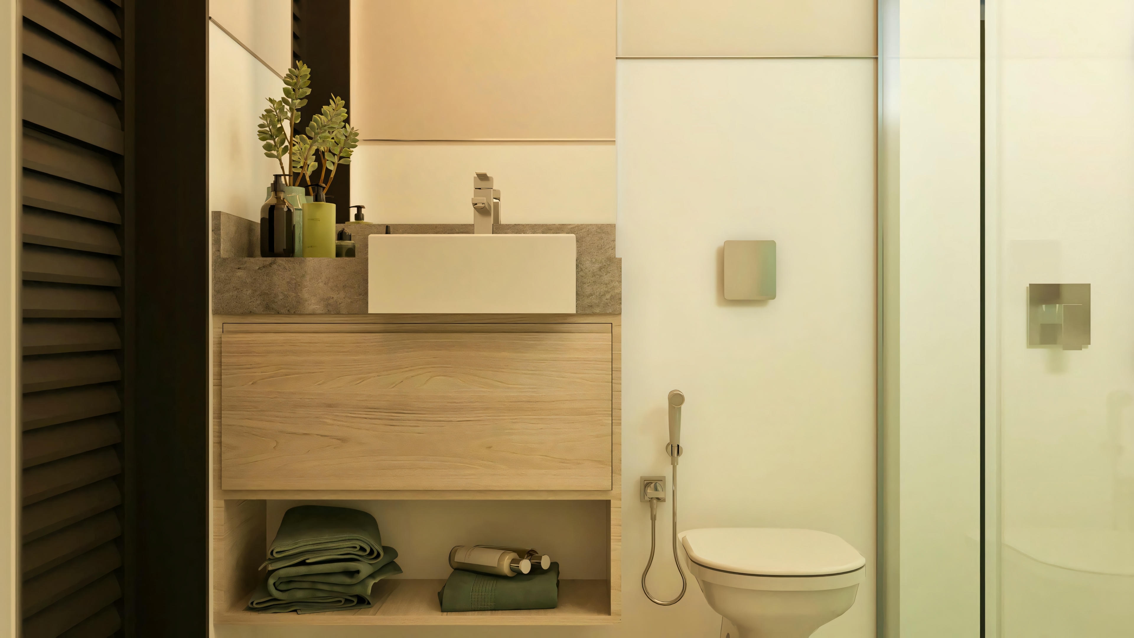 Aseo o baño social del proyecto de casa de dos pisos 330m², mostrando encimera de piedra gris con lavabo de apoyo blanco, mueble de madera clara con nicho inferior e inodoro con cisterna empotrada.