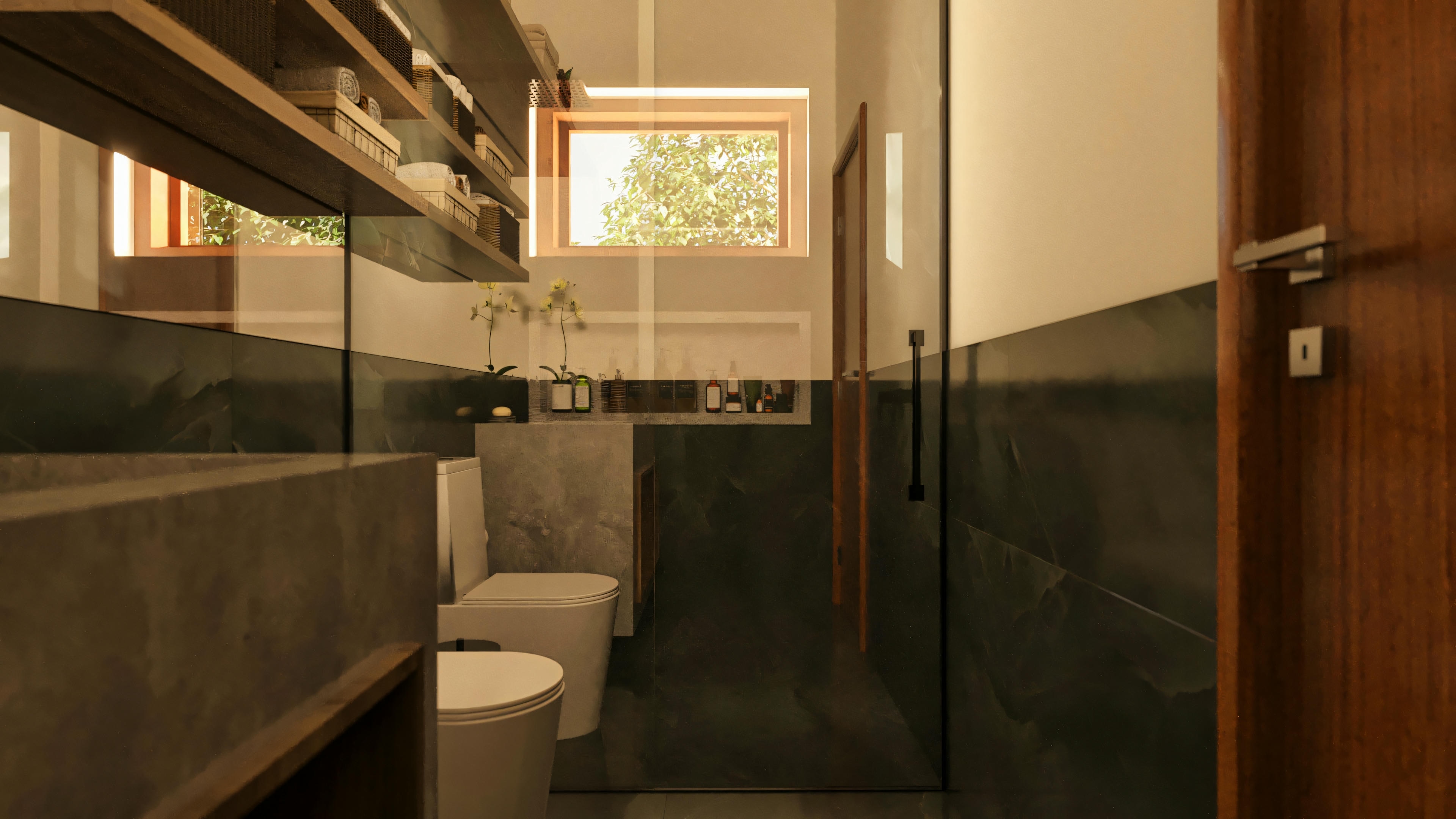 Vista interna del baño de una suite en casa de lujo, mostrando el inodoro y bidé, revestimiento de piedra oscura en paredes y suelo, ducha con mampara de vidrio, estanterías de madera y ventana al fondo.