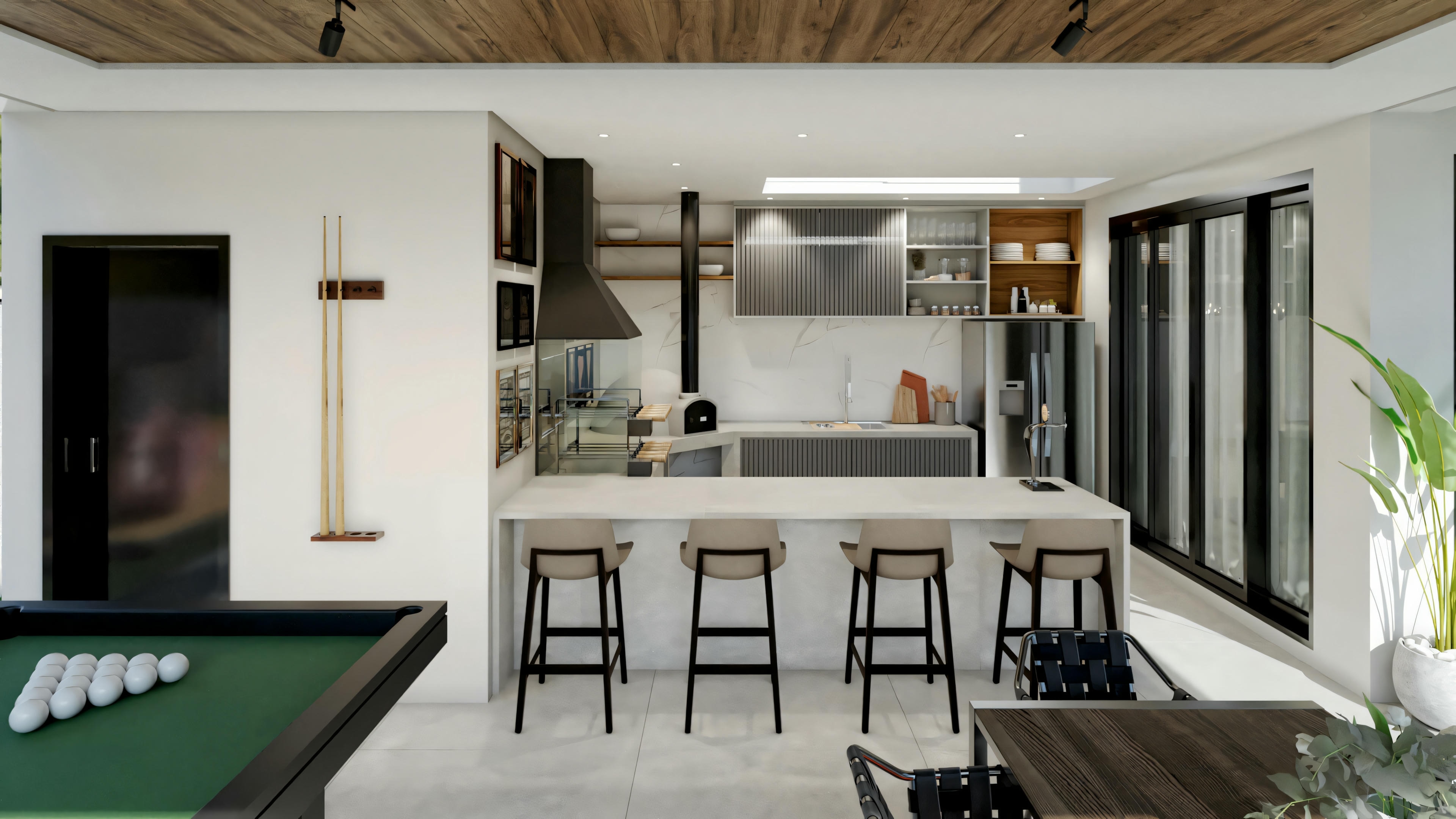 Una cocina moderna con barra y taburetes a un lado, y una mesa de billar en primer plano.