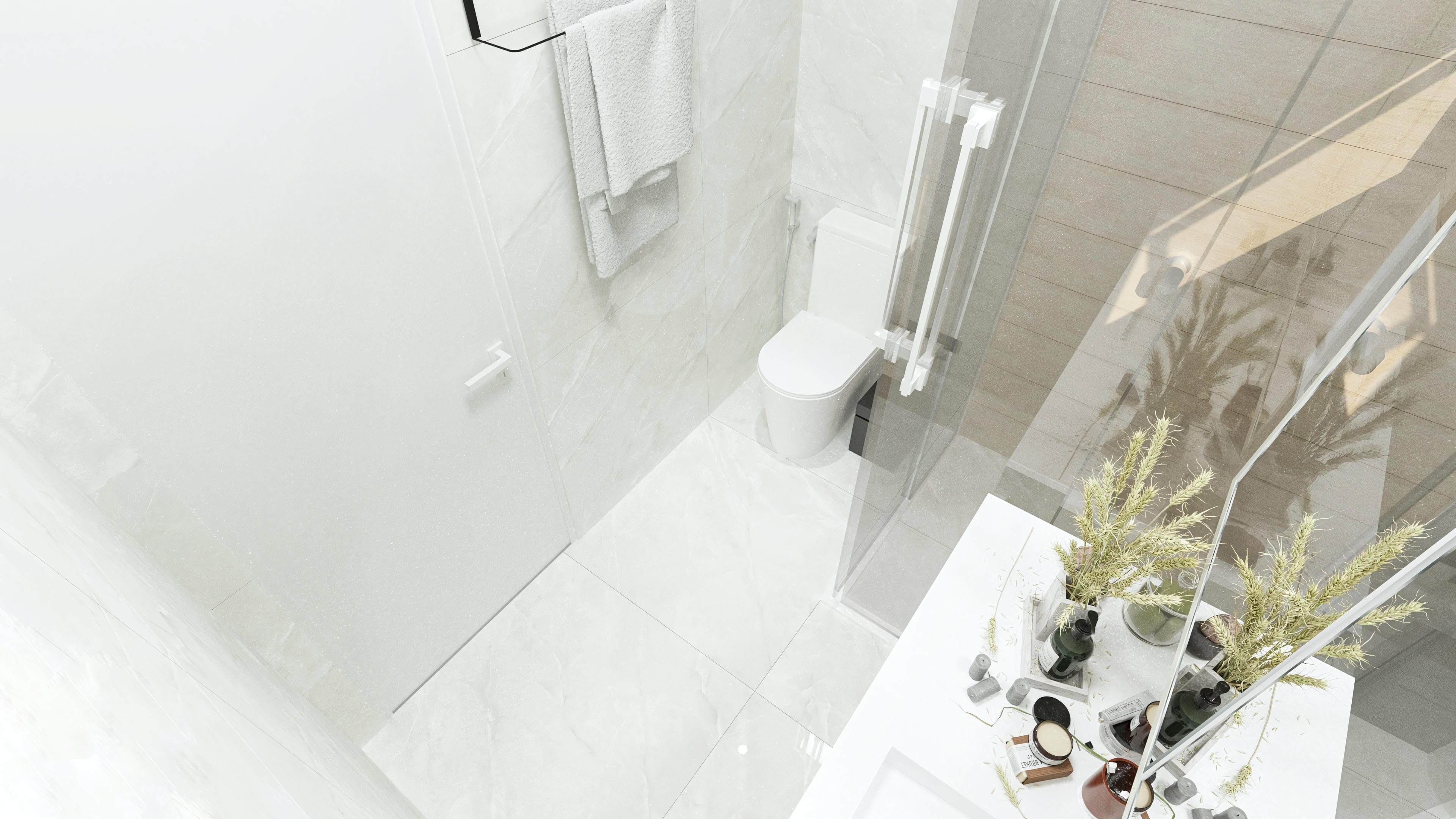 Detail of a modern bathroom with light marbled porcelain tile cladding on the walls and floor, transparent glass shower enclosure, and white towels.