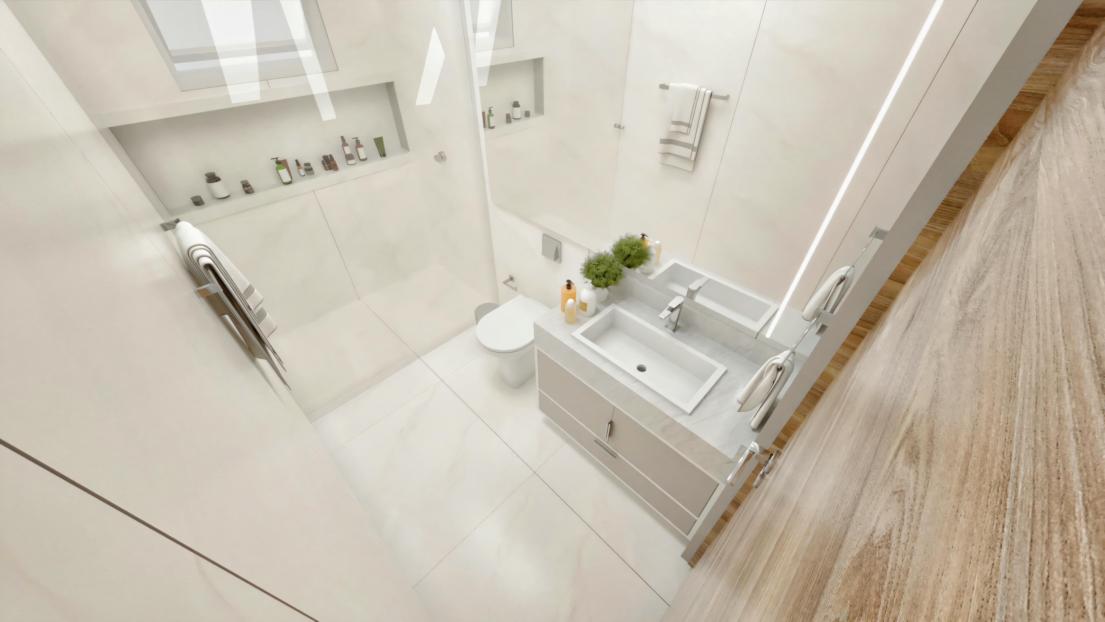 Cuarto de baño compacto con predominio de blanco y gris claro, encimera gris con lavabo de sobreponer rectangular blanco, inodoro, mampara de ducha de cristal de suelo a techo, amplia hornacina empotrada en la ducha y toalleros cromados.