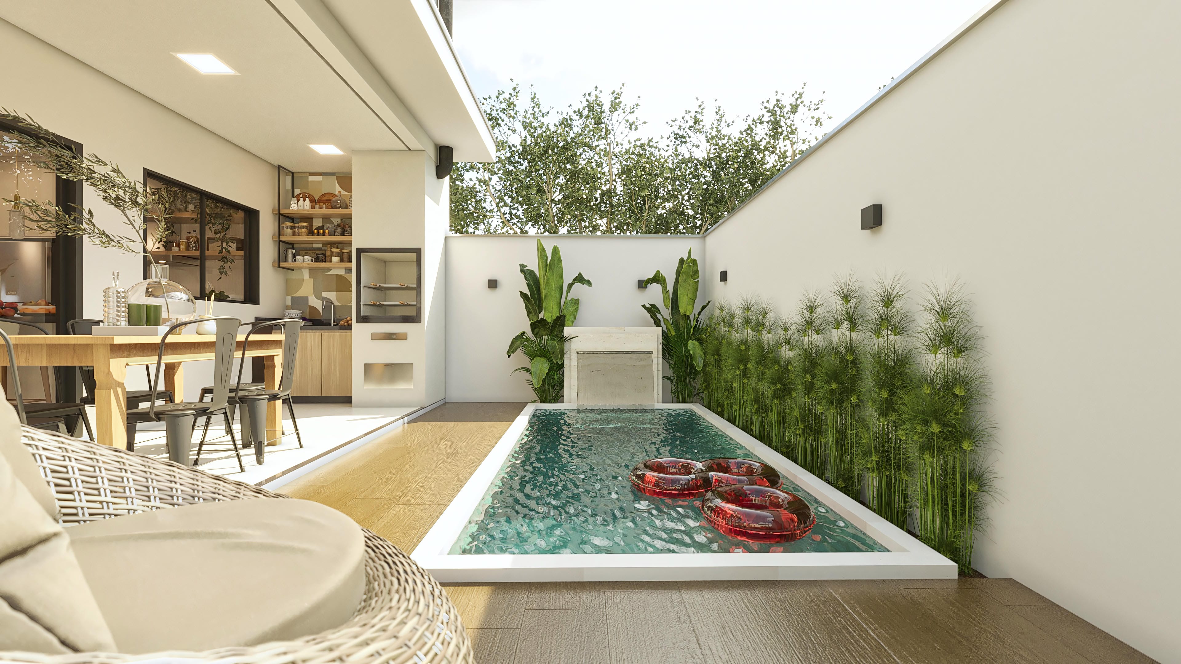 Visão externa de área de lazer com piscina retangular, cascata, deck de madeira e espaço gourmet integrado.
