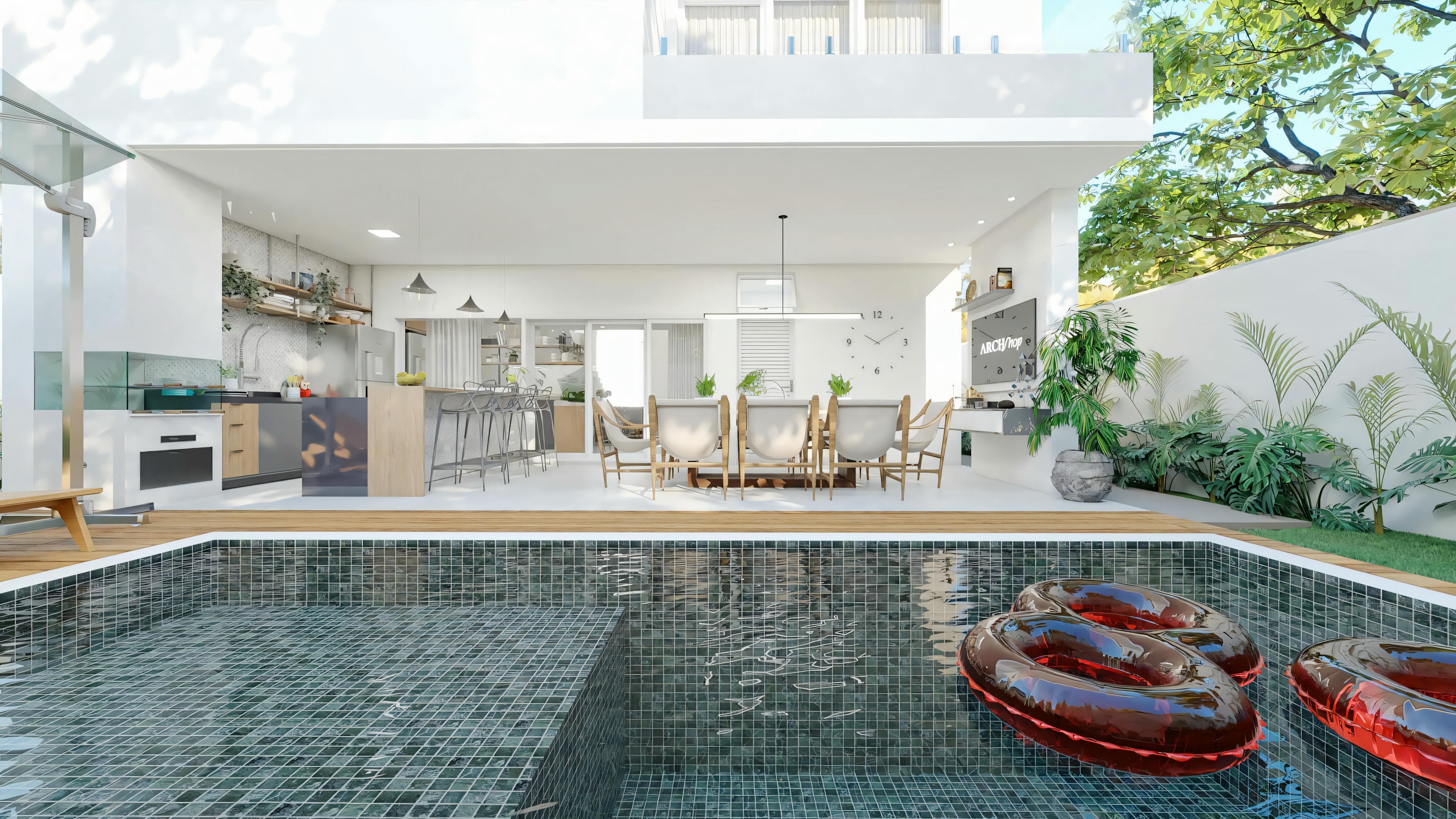Complete leisure area with pool coated in dark tiles, wooden deck and integrated gourmet space in Archshop residential project. View from the pool to the single-story 3-bedroom house plan, showing the gourmet kitchen, outdoor dining area and landscaping.
