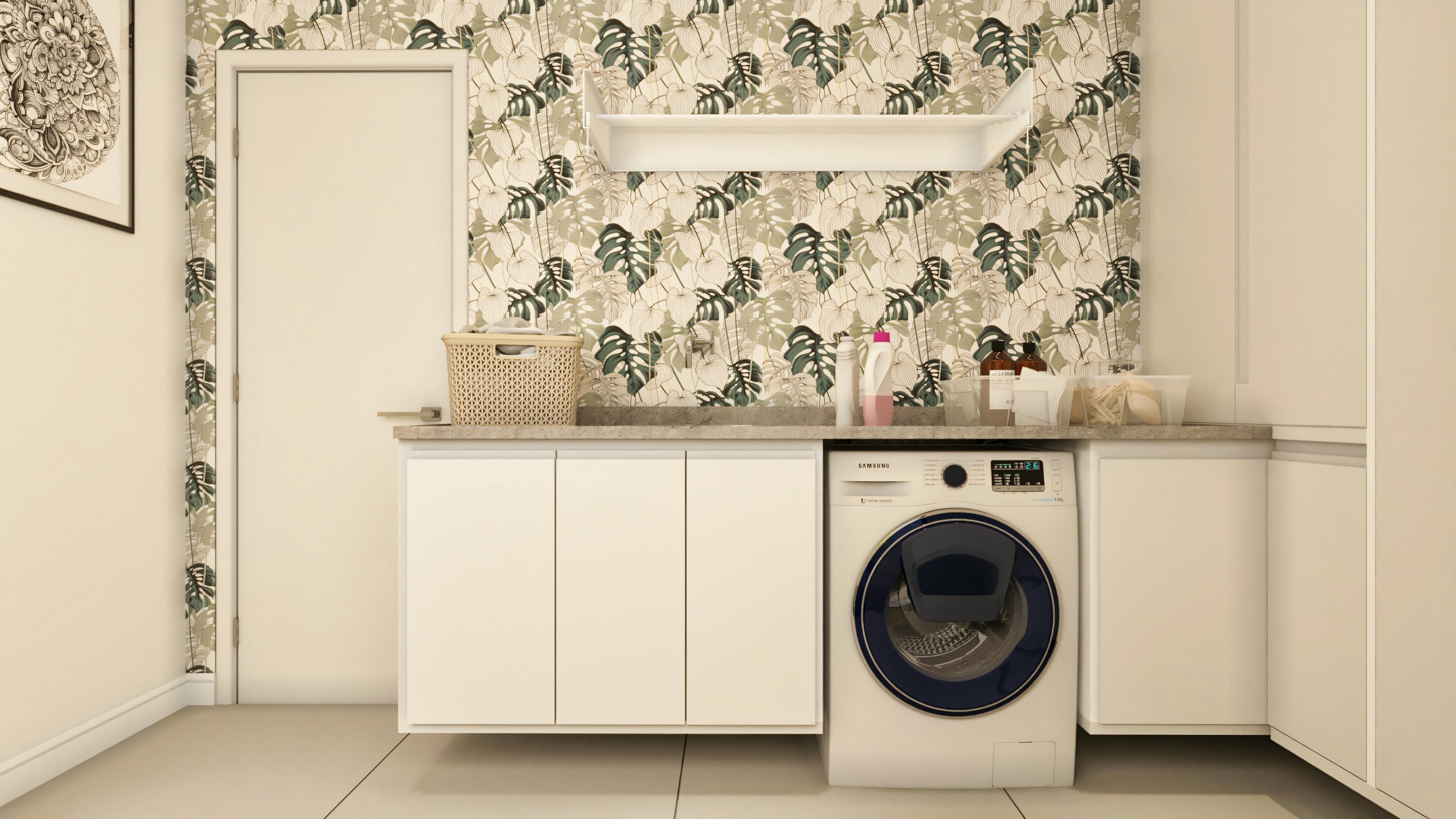 Equipped and decorated laundry room in a high-standard house, with front-loading washing machine, support counter, planned white cabinets, and botanical print wallpaper (philodendron).