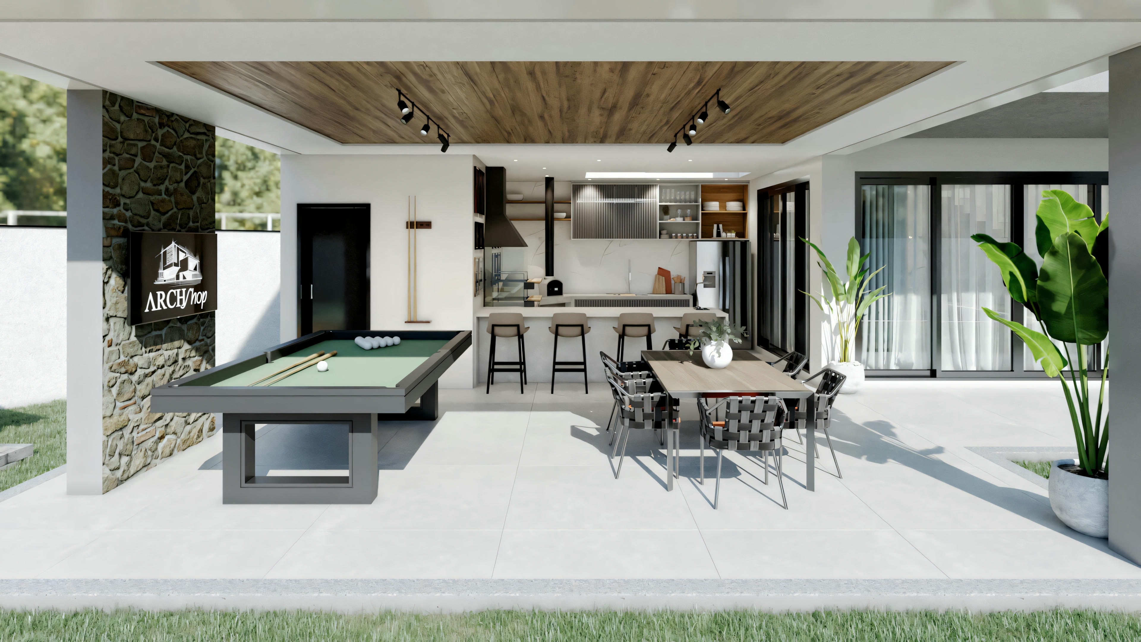A patio under a cover with a ceiling fan, including an outdoor kitchen area with bar stools and a dining area.