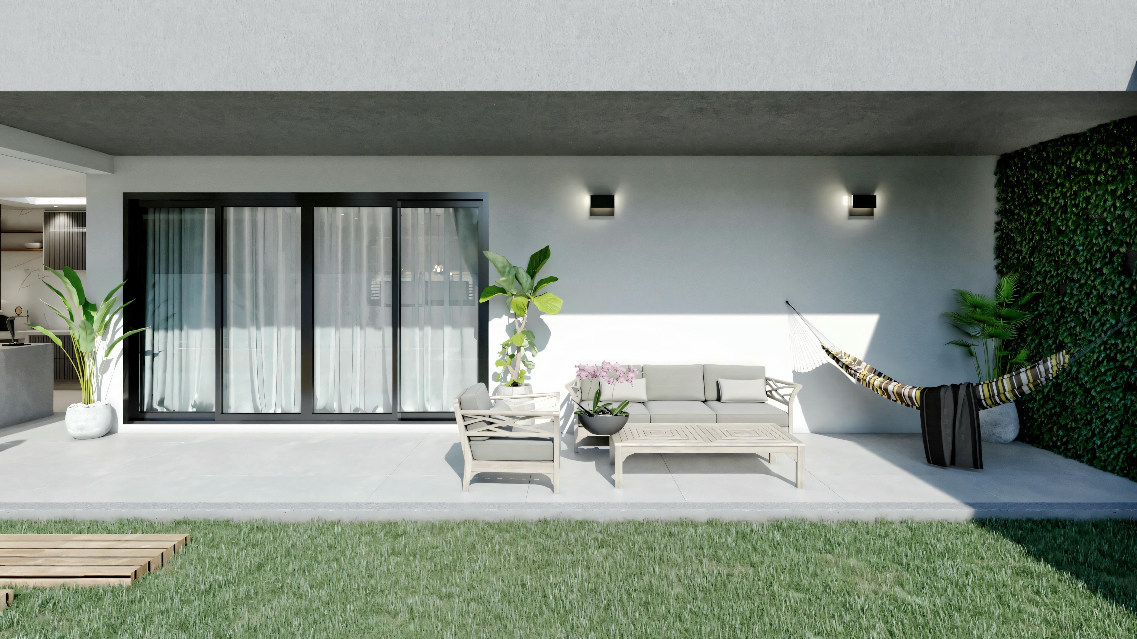 A modern house with large glass windows and an outdoor seating area.