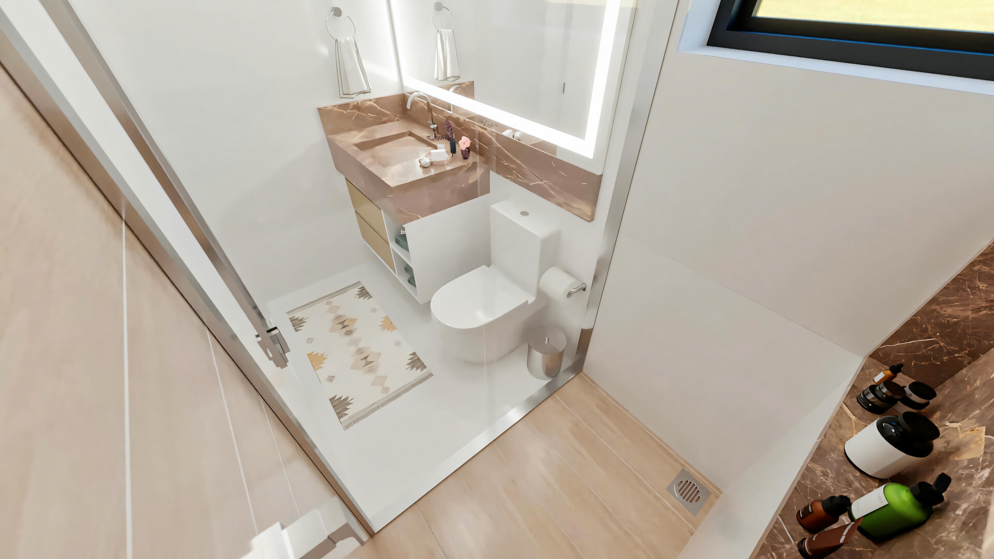 Modern bathroom of one of the 5 suites in the ready-made project, featuring a brown marble countertop, illuminated LED mirror, white toilet, and glass shower enclosure.