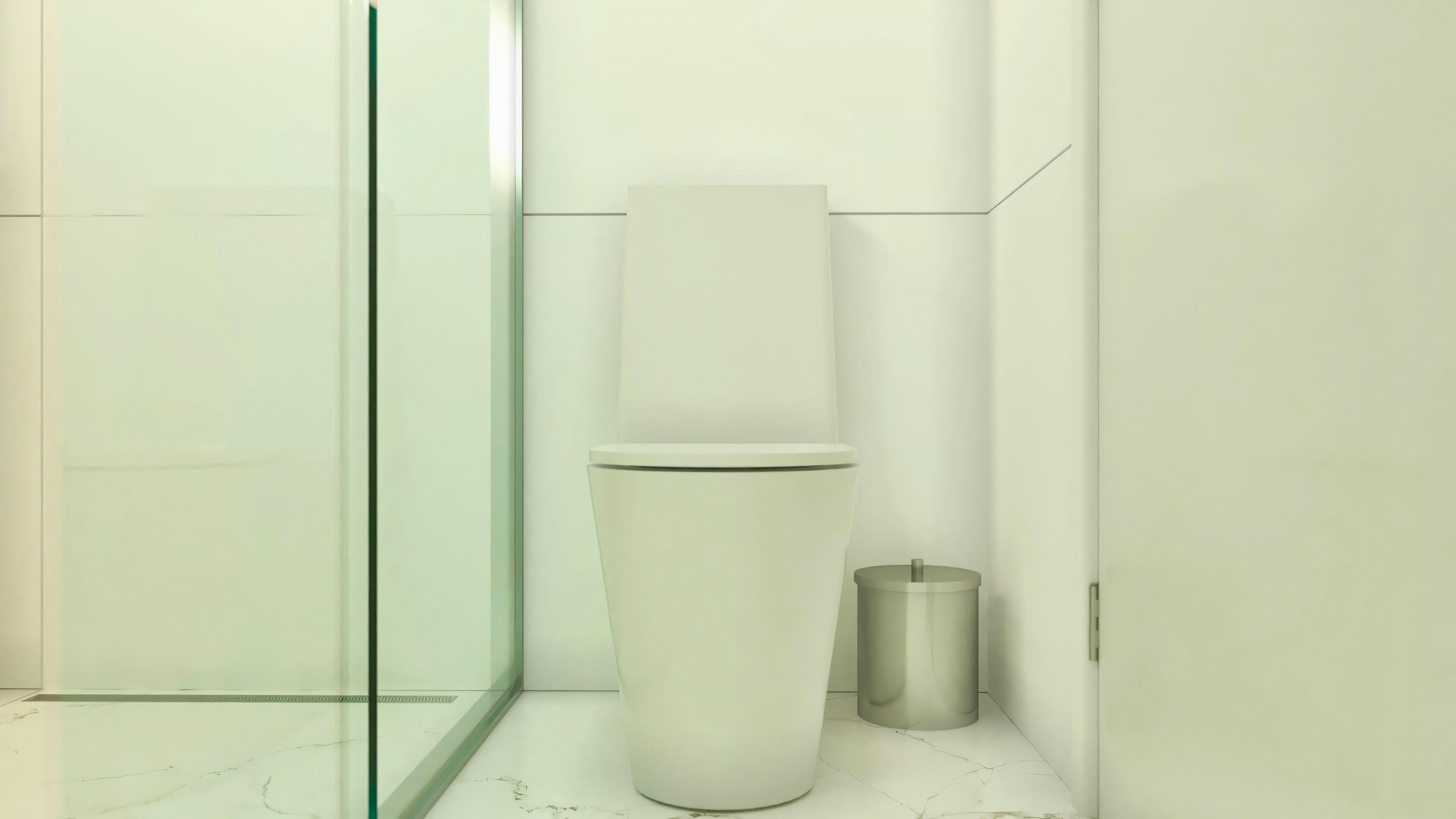 Detail of a bathroom in a luxury house project, focusing on the modern design toilet next to a glass shower enclosure and marble-look flooring.
