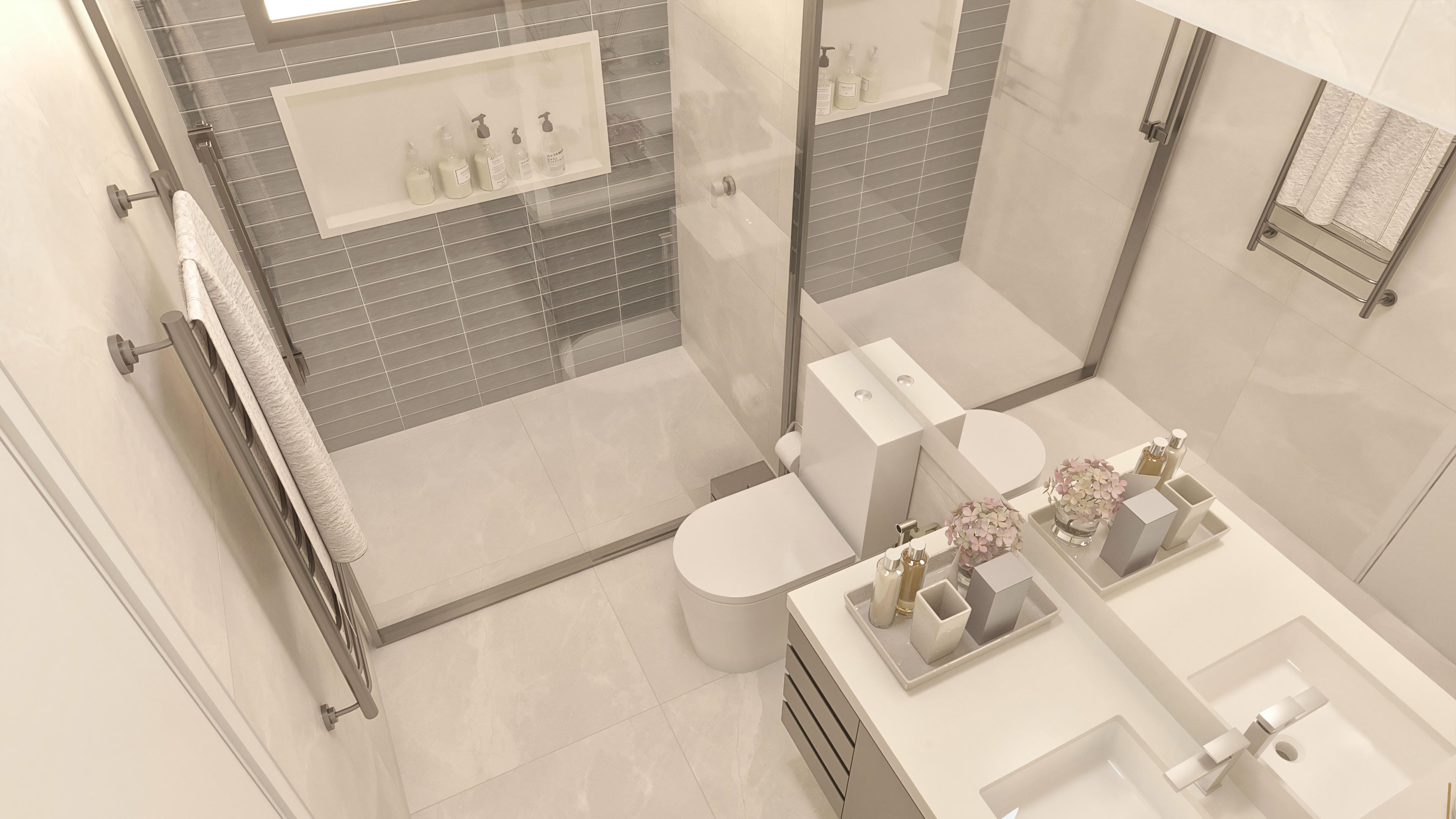 Modern bathroom with light-toned claddings and gray details, glass shower stall, and a vanity with double sinks.
