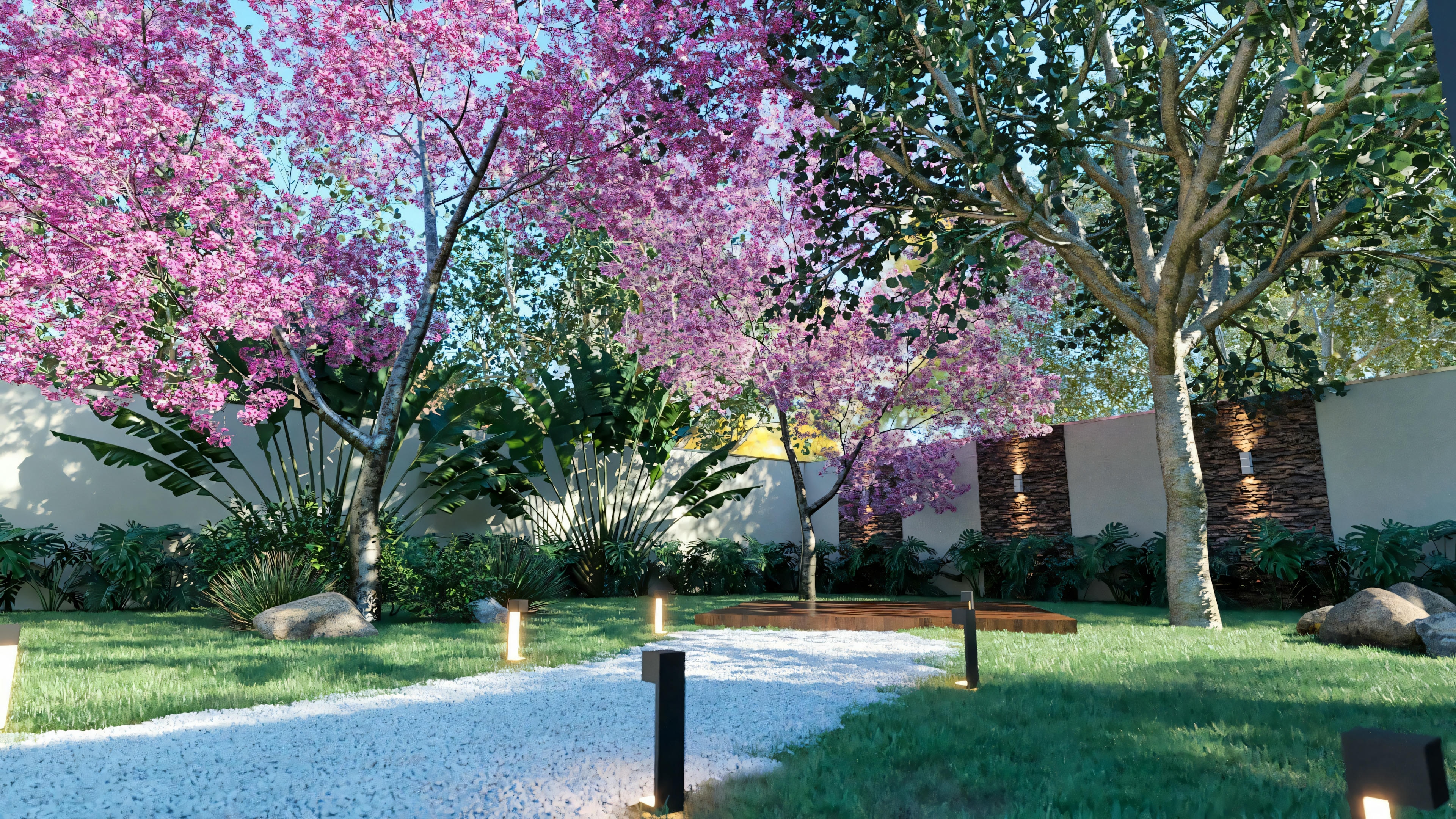 Detalle del paisajismo en el jardín de la casa de planta baja con 3 suites, mostrando sendero de gravilla, iluminación de jardín, árboles floridos (ipês) y césped. Proyecto casa planta baja 3 suites.