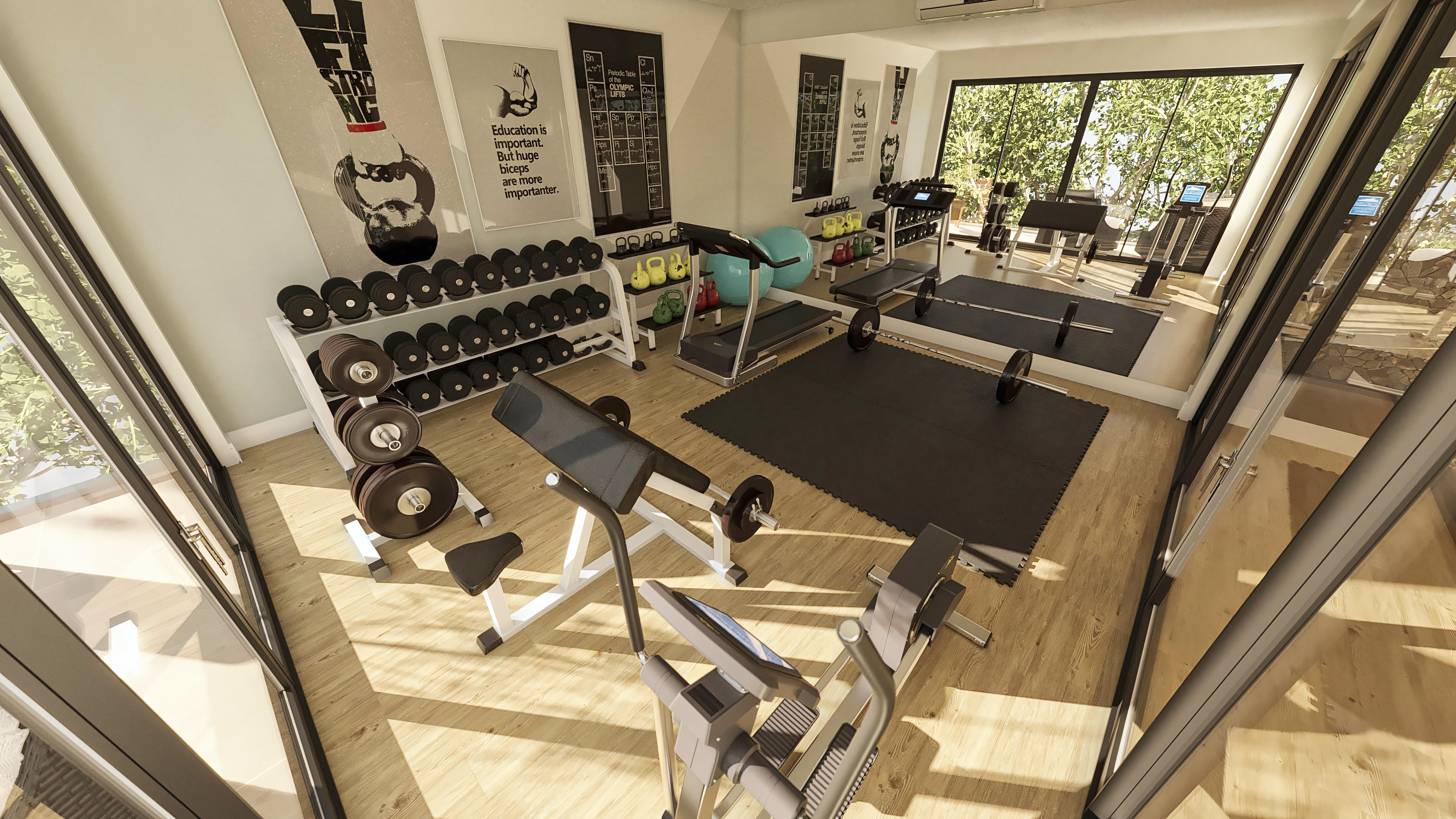 Modern gym space with light wood floor, weight racks, cardio equipment, and large windows revealing lush landscaping.
