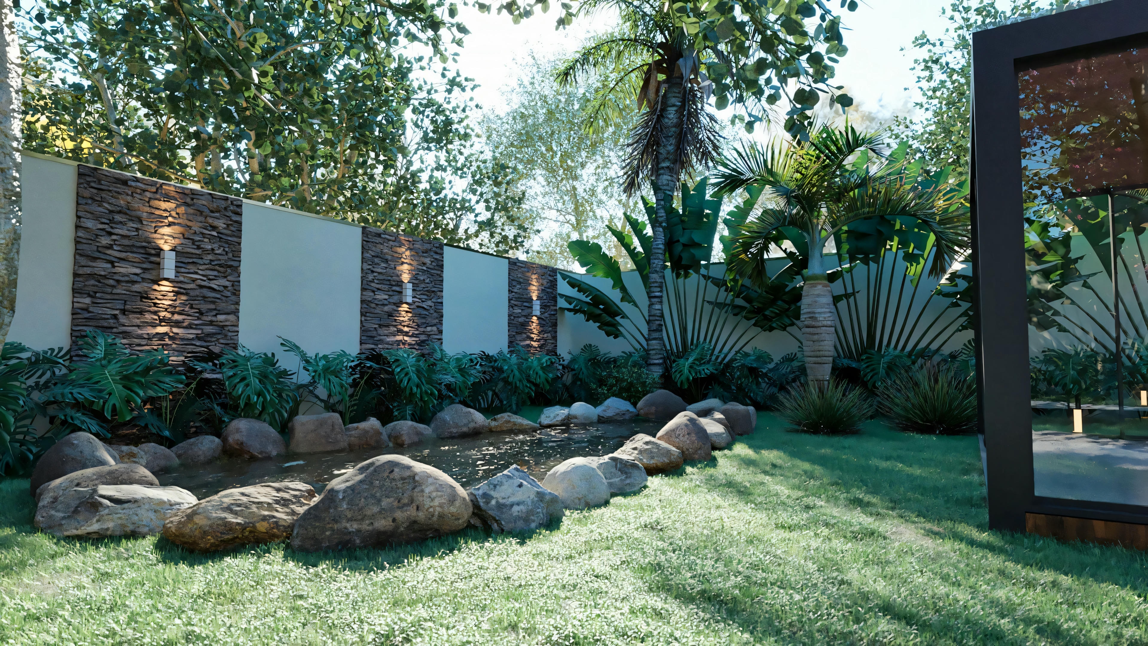 Detail of the landscaping in the garden of the bungalow house with 3 suites, featuring an ornamental lake with stones, lawn, and a wall with stone cladding and lighting.