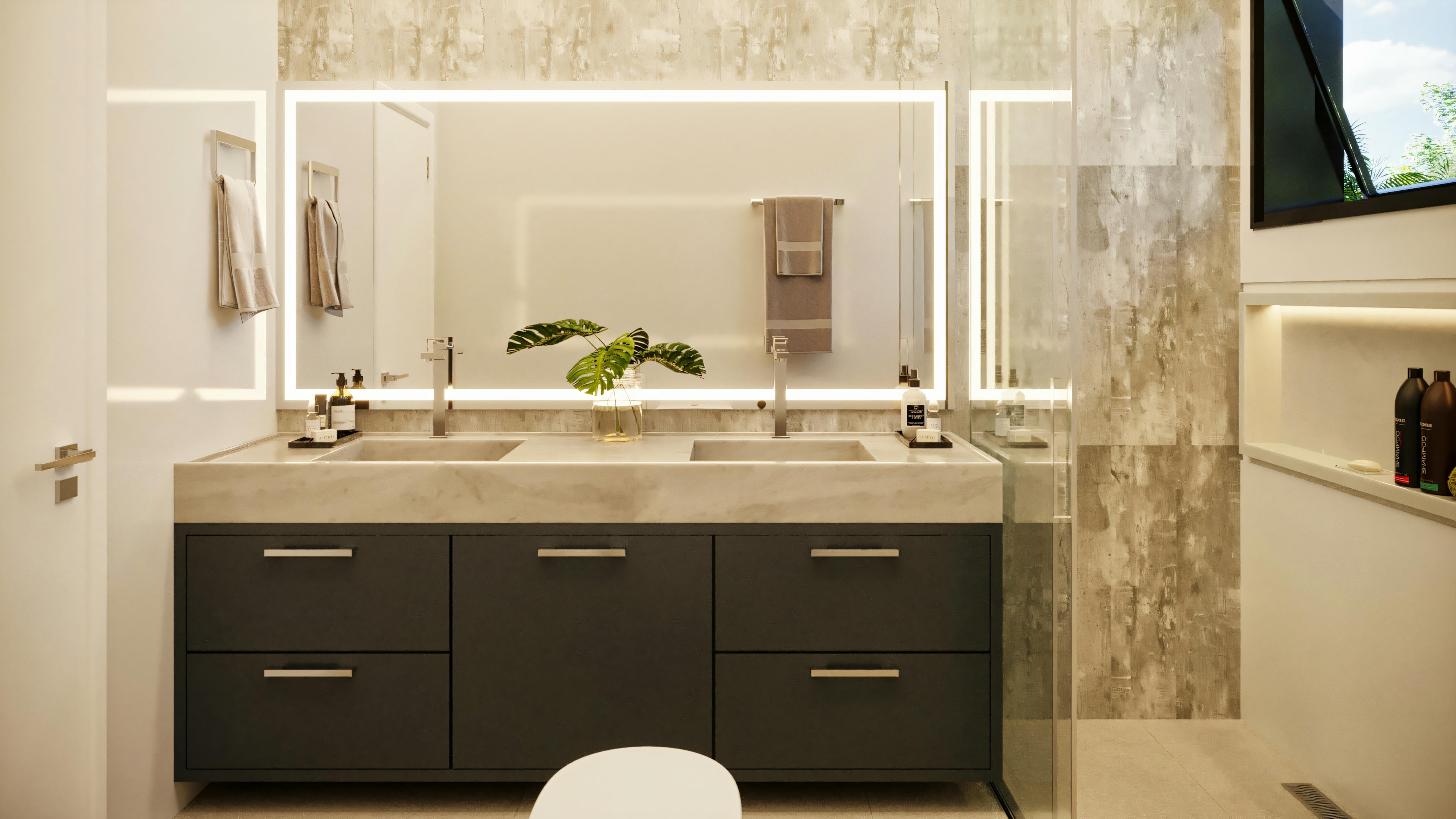 Close-up de la encimera con lavabo doble en baño principal de casa de planta baja con 3 suites, exhibiendo armarios inferiores oscuros, espejo con iluminación LED y revestimiento de piedra en la pared.