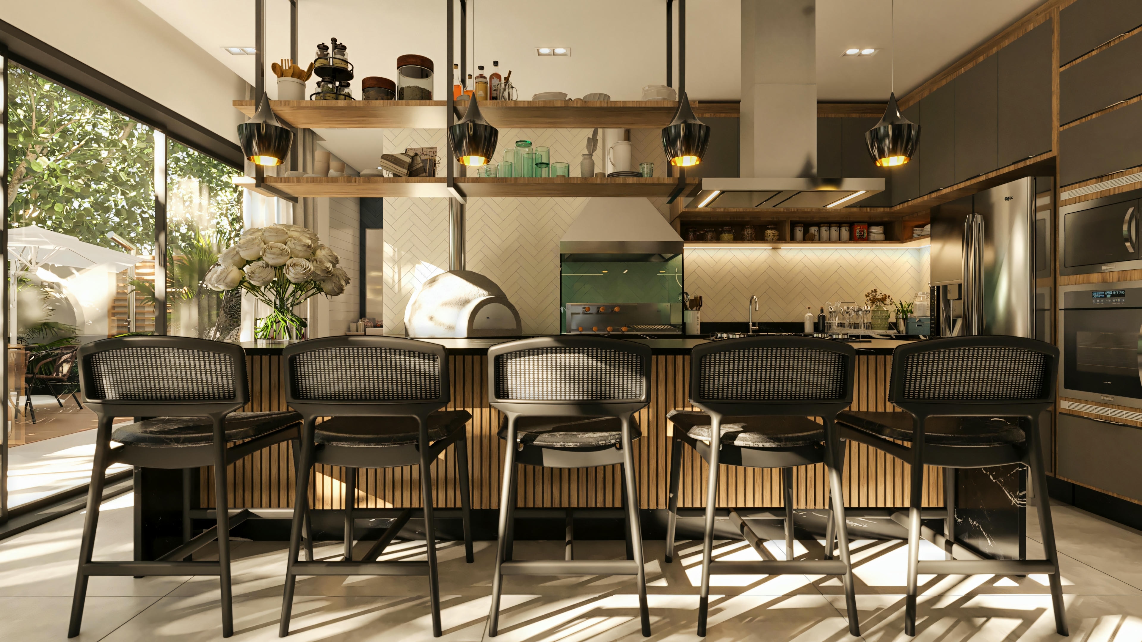 Modern kitchen and gourmet area of the high-standard 5-suite house, equipped with a central island with black countertop, slatted panel and stools, planned gray cabinets, stainless steel appliances, pizza oven, and access to the outdoor area.